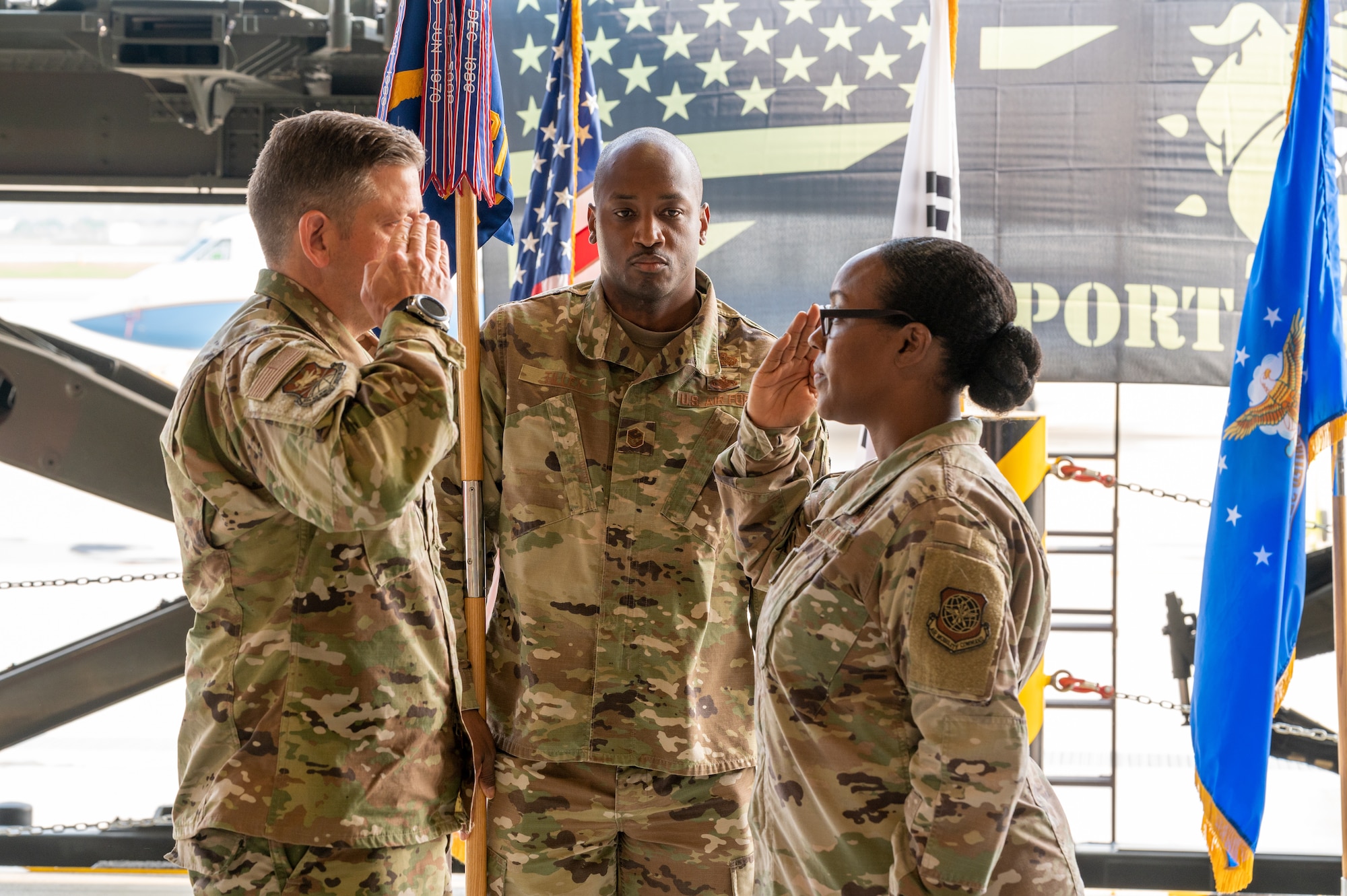 Col. Christopher Kiser, 515th Air Mobility Operations Group commander, left, returns a salute to Lt. Col. Sabrina Winter, 731st Air Mobility Squadron incoming commander, during the change of command ceremony at Osan Air Base, Republic of Korea, July 1, 2021. As the presiding officer, Kiser facilitated the transition of 731st AMS command by receiving the ceremonial guidon from the outgoing officer and presenting it to the incoming officer. (U.S. Air Force photo by Tech. Sgt. Nicholas Alder)
