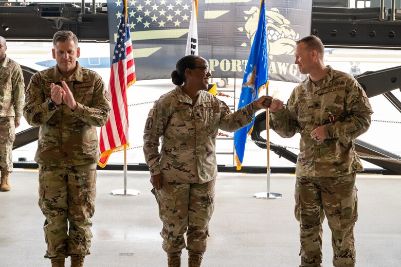 Lt. Col. Ryan Murray, 731st Air Mobility Squadron outgoing commander, right, shares a congratulatory fist bump with Lt. Col. Sabrina Winters, 731st AMS inbound commander, during the change of command at Osan Air Base, Republic of Korea, July 1, 2021. With the passing of the guidon, Winters begins her tenure as the commander of the 731st AMS. (U.S. Air Force photo by Tech. Sgt. Nicholas Alder)