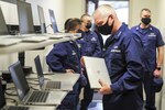 Vice Adm. Steven Poulin, Coast Guard Atlantic Area Commander, interacts with Coast Guard Training Center Yorktown’s current technological training equipment, March 23, 2021. Poulin studied the equipment inside one of the training center’s server rooms during a recent tour. U.S. Coast Guard photo by Seaman Santiago Gomez.