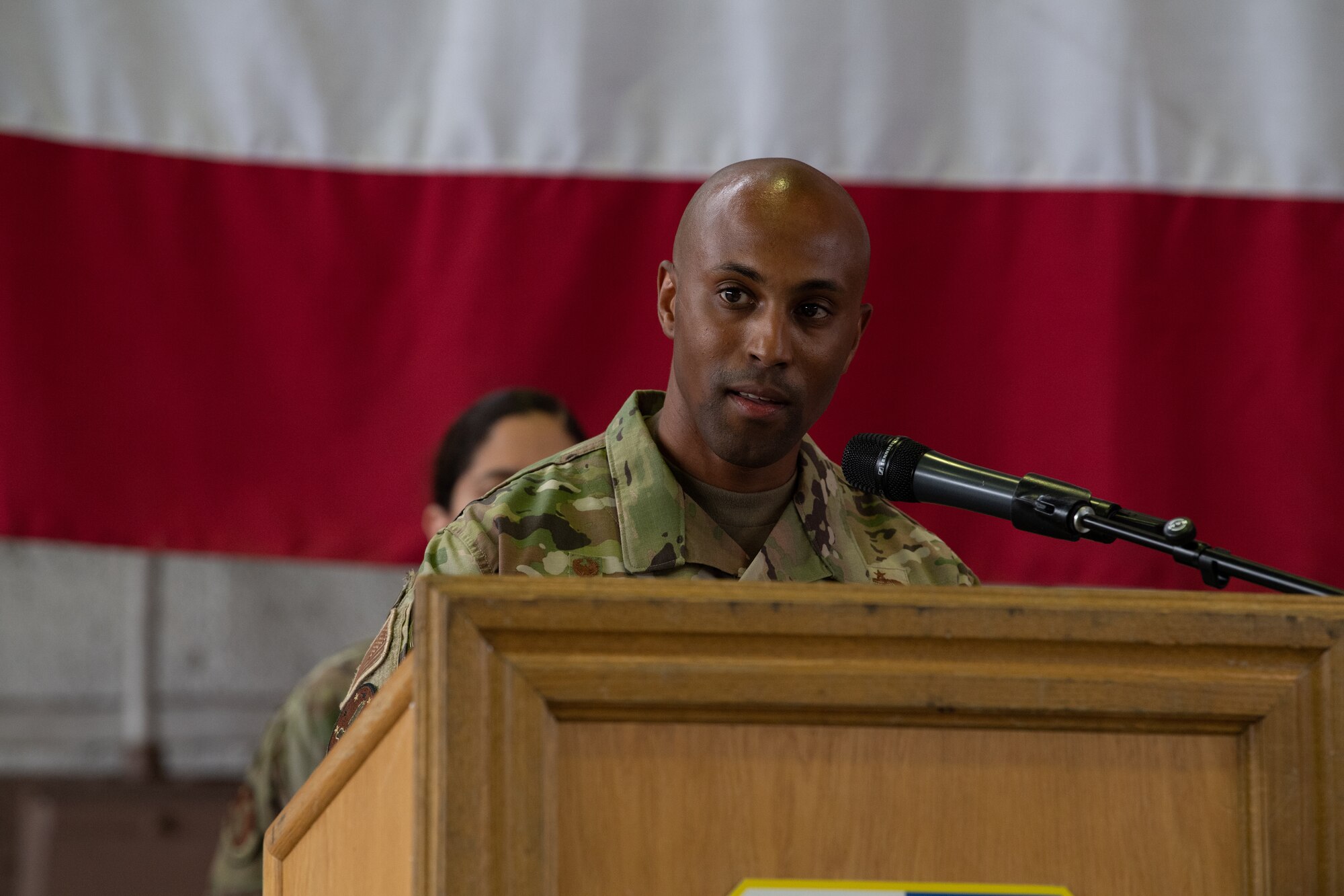 U.S. Air Force Maj. Lee Washington, the 52nd Comptroller Squadron commander, addresses the crowd at the 52nd CPTS change of command ceremony at Spangdahlem Air Base, Germany, June 30, 2021. The CPTS is responsible for the purchasing and financial allocation needs of the 52nd FW. (U.S. Air Force photo by Senior Airman Ali Stewart)