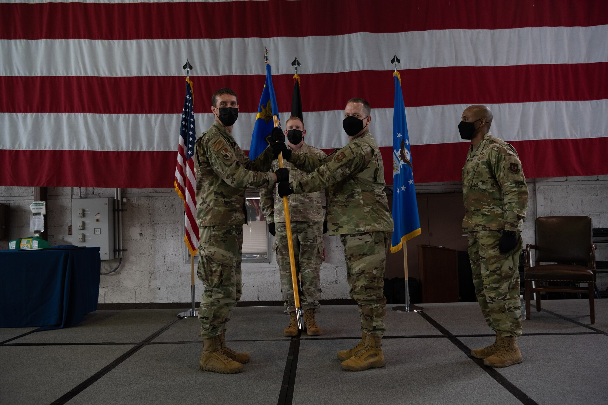 U.S. Air Force Lt. Col Shawn Schulz, outgoing 52nd Comptroller Squadron commander (right), passes the guidon to Col. David Epperson, 52nd Fighter Wing commander, at the 52nd CPTS change of command ceremony at Spangdahlem Air Base, Germany, June 30, 2021. Throughout his time at Spangdahlem AB, Schulz increased the cost-of-living allowance for more than 5,000 personnel by more than 80%. (U.S. Air Force photo by Senior Airman Ali Stewart)