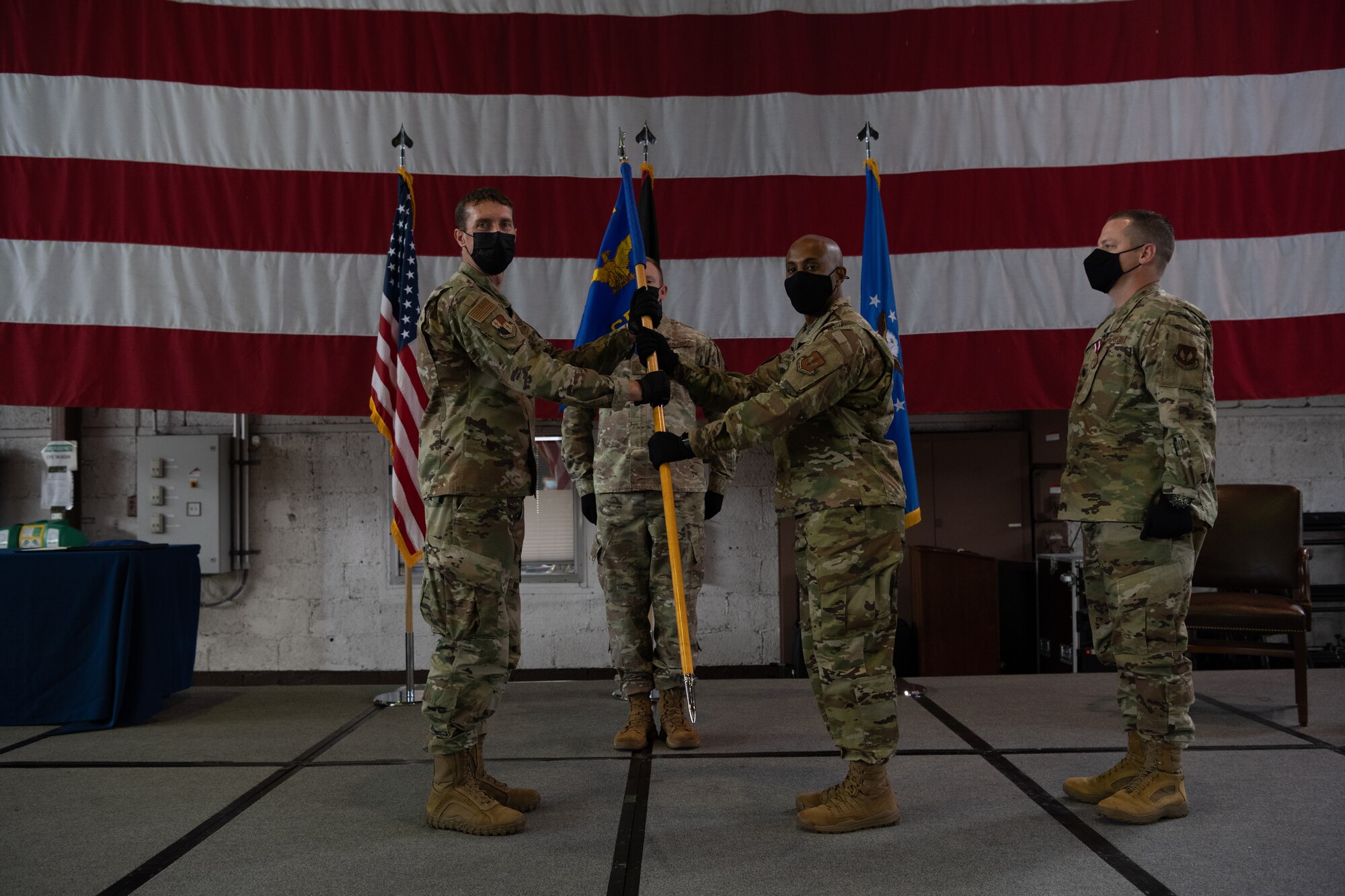 U.S. Air Force Col. David Epperson, 52nd Fighter Wing commander (left), passes the 52nd Comptroller Squadron guidon to Maj. Lee Washington, incoming 52nd CPTS commander, at the 52nd CPTS change of command ceremony at Spangdahlem Air Base, June 30, 2021. The commander of the comptroller squadron also is responsible for overseeing the Wing Staff Agencies, which encompasses many flights such as Command Post, Public Affairs and the base legal office. (U.S. Air Force photo by Senior Airman Ali Stewart)