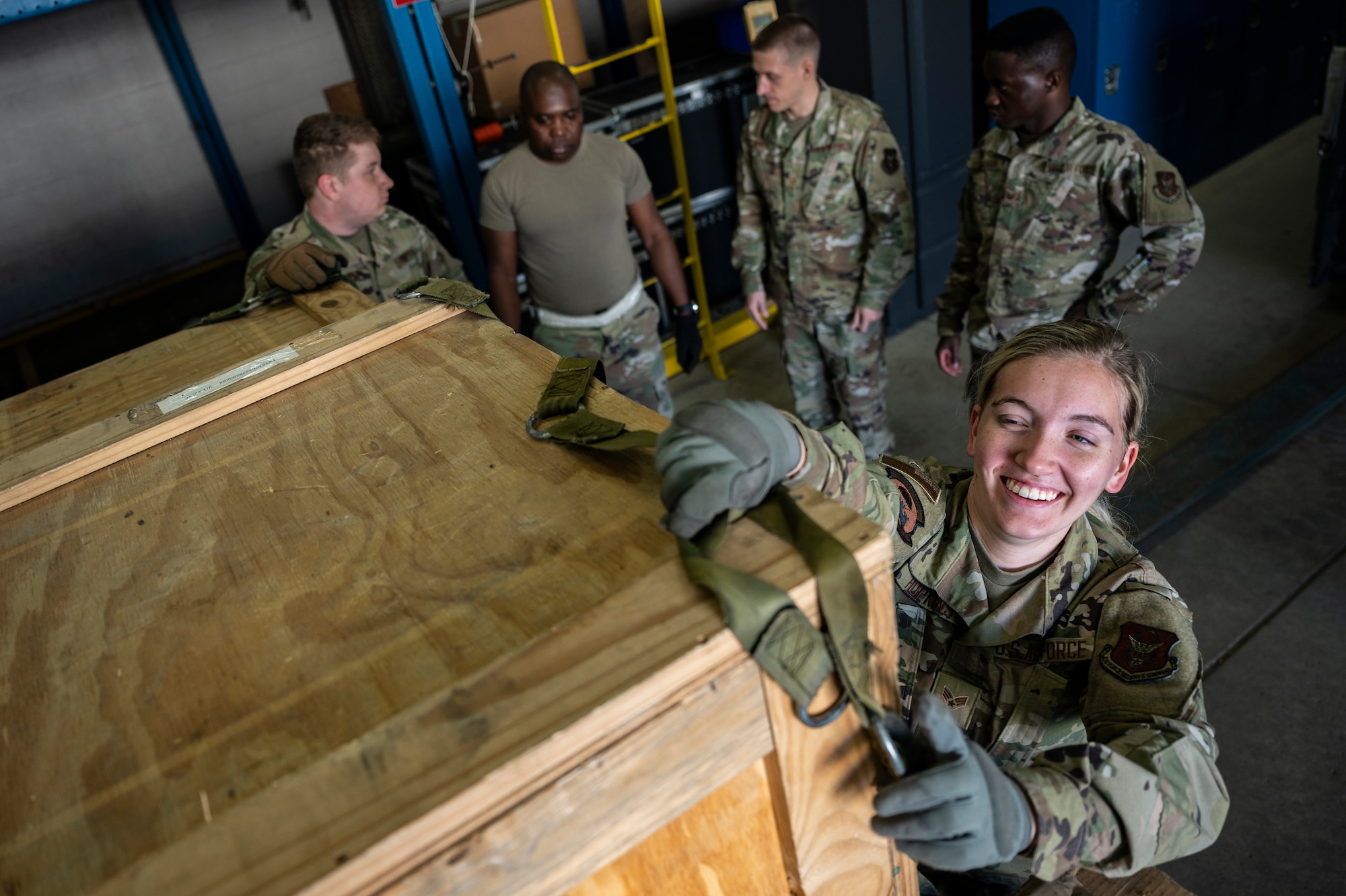 Senior Airman Abigail Hopkins, 32nd Aerial Port Squadron cargo specialist, pulls a net over a cargo pallet during a pallet building training scenario at the Pittsburgh International Airport Air Reserve Station, Pennsylvania, June 16, 2021.