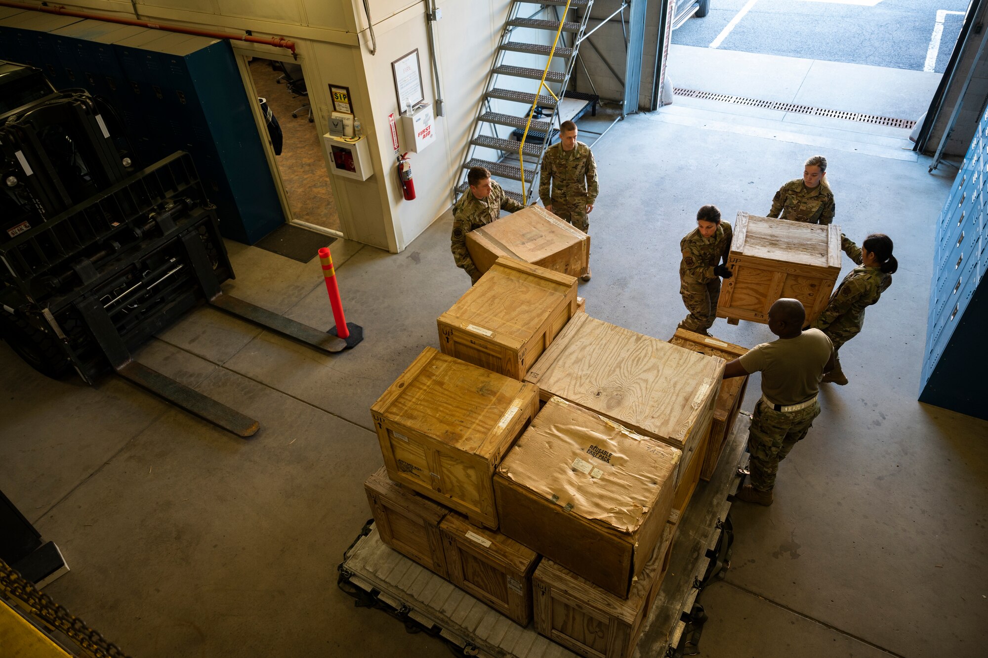 Airmen assigned to the 32nd Aerial Port Squadron build up a cargo pallet as part of a training scenario at the Pittsburgh International Airport Air Reserve Station, Pennsylvania, June 16, 2021.