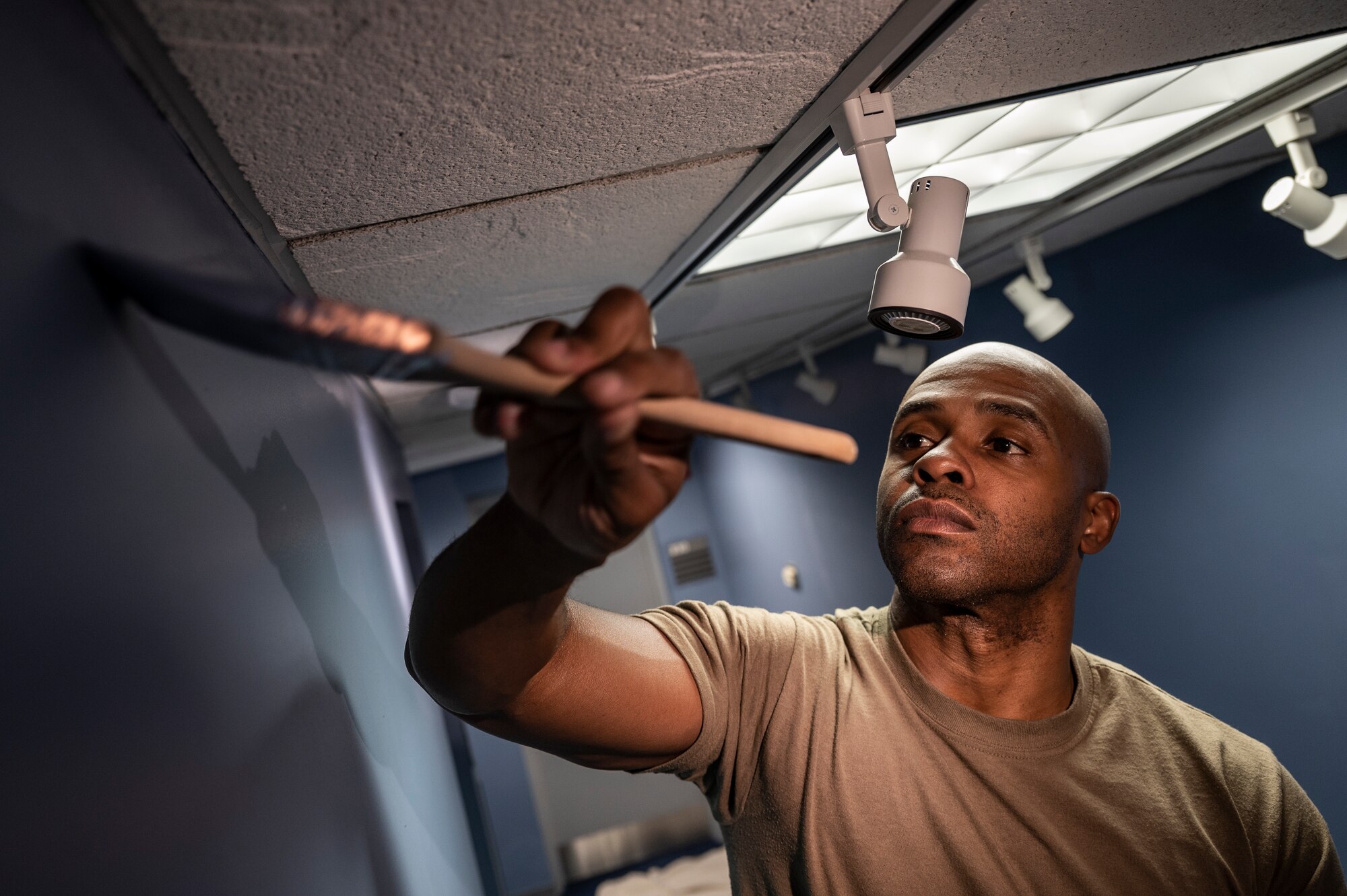 Staff Sgt. Antoine Jackson, 911th Civil Engineering Squadron structures technician, paints a wall in the headquarters building at the Pittsburgh International Airport Air Reserve Station, Pennsylvania, June 9, 2021.