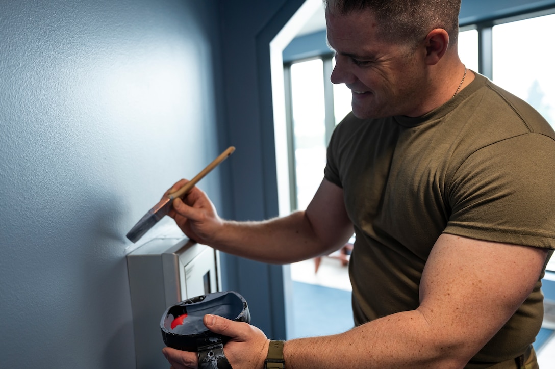 Staff Sgt. Joel Dennis, 911th Civil Engineering Squadron structures technician, paints a wall in the headquarters building at the Pittsburgh International Airport Air Reserve Station, Pennsylvania, June 9, 2021.