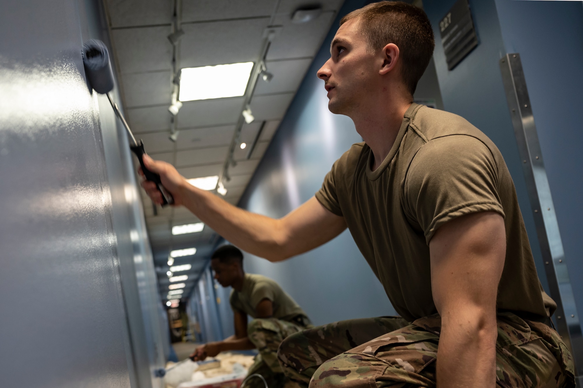 Senior Airman Franklin Geidner, 911th Civil Engineering Squadron roads and ground technician and Staff Sgt. Terique Howard, 911th CES structures technician, paint a wall in the headquarters building at the Pittsburgh International Airport Air Reserve Station, Pennsylvania, June 9, 2021.