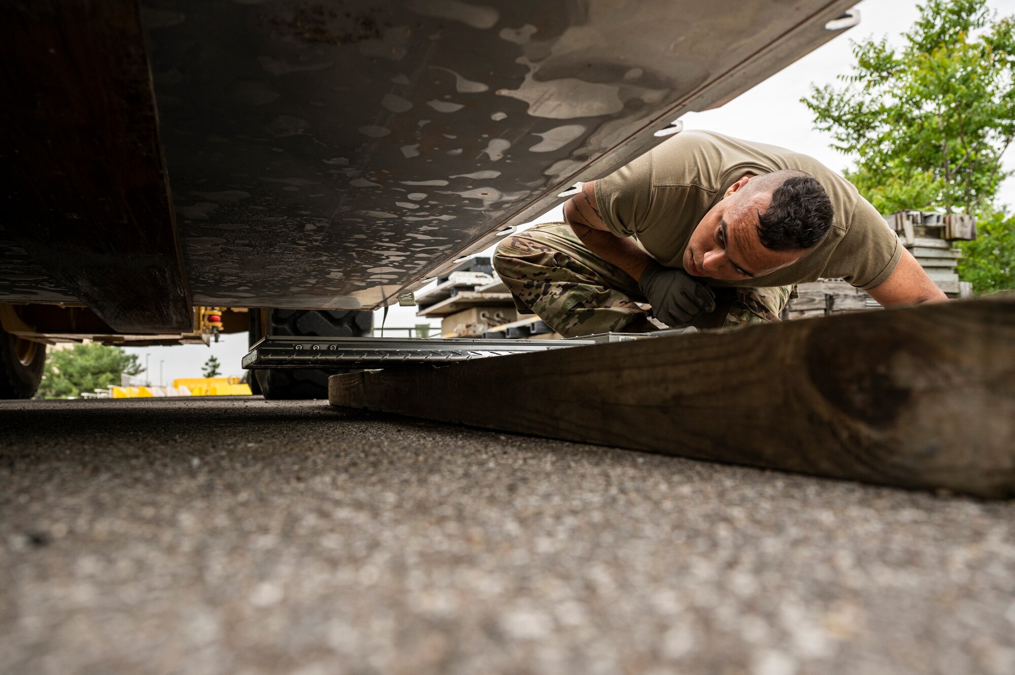Senior Airman Zach Long, 32nd Aerial Port Squadron passenger services operations technician, checks the placement of a scale before weighing a pallet of cargo at the Pittsburgh International Airport Air Reserve Station, Pennsylvania, May 28, 2021.