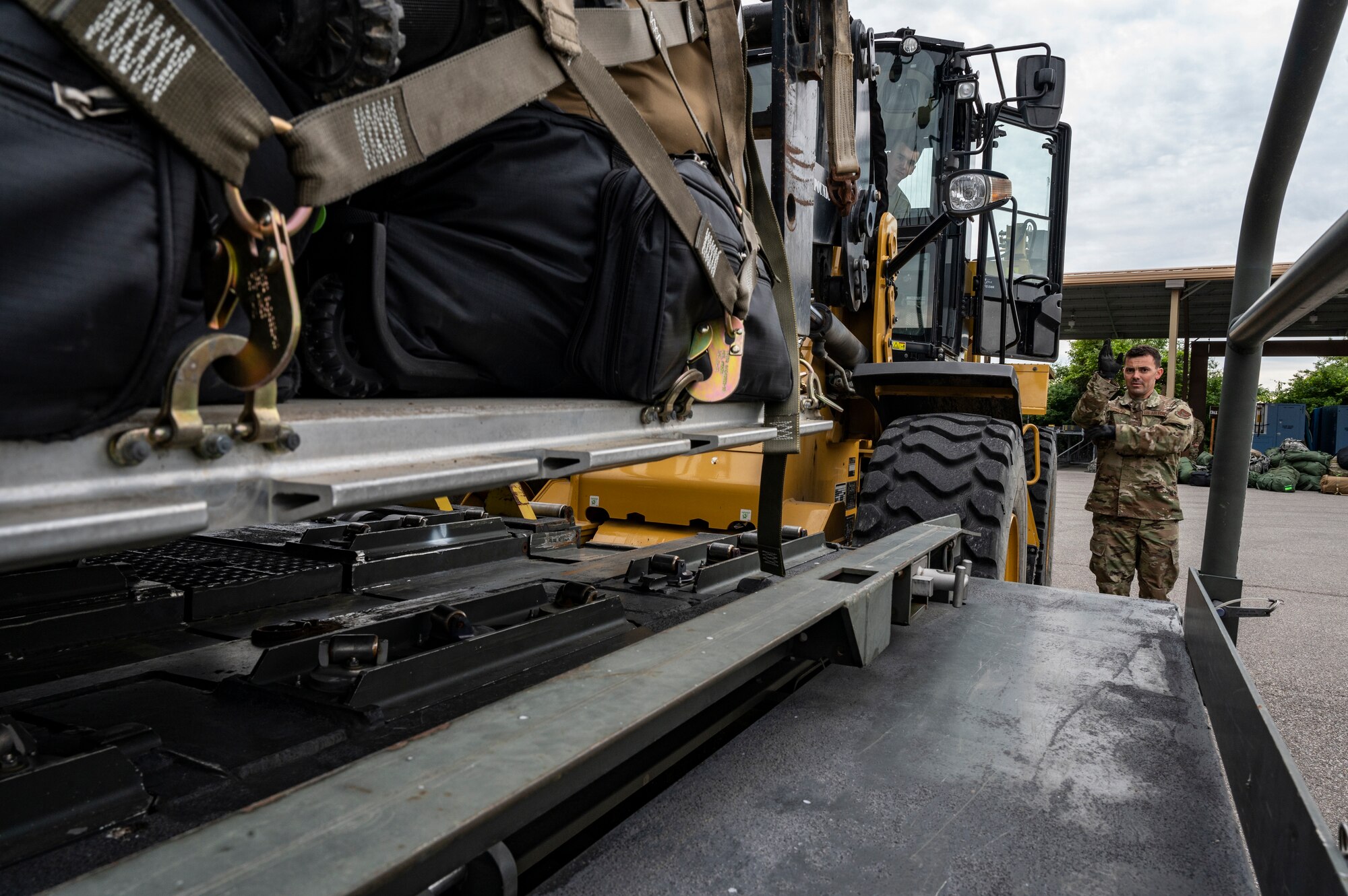 Airmen assigned to the 32nd Aerial Port Squadron load a pallet of cargo onto a 25K Halverson loader at the Pittsburgh International Airport Air Reserve Station, Pennsylvania, May 28, 2021.