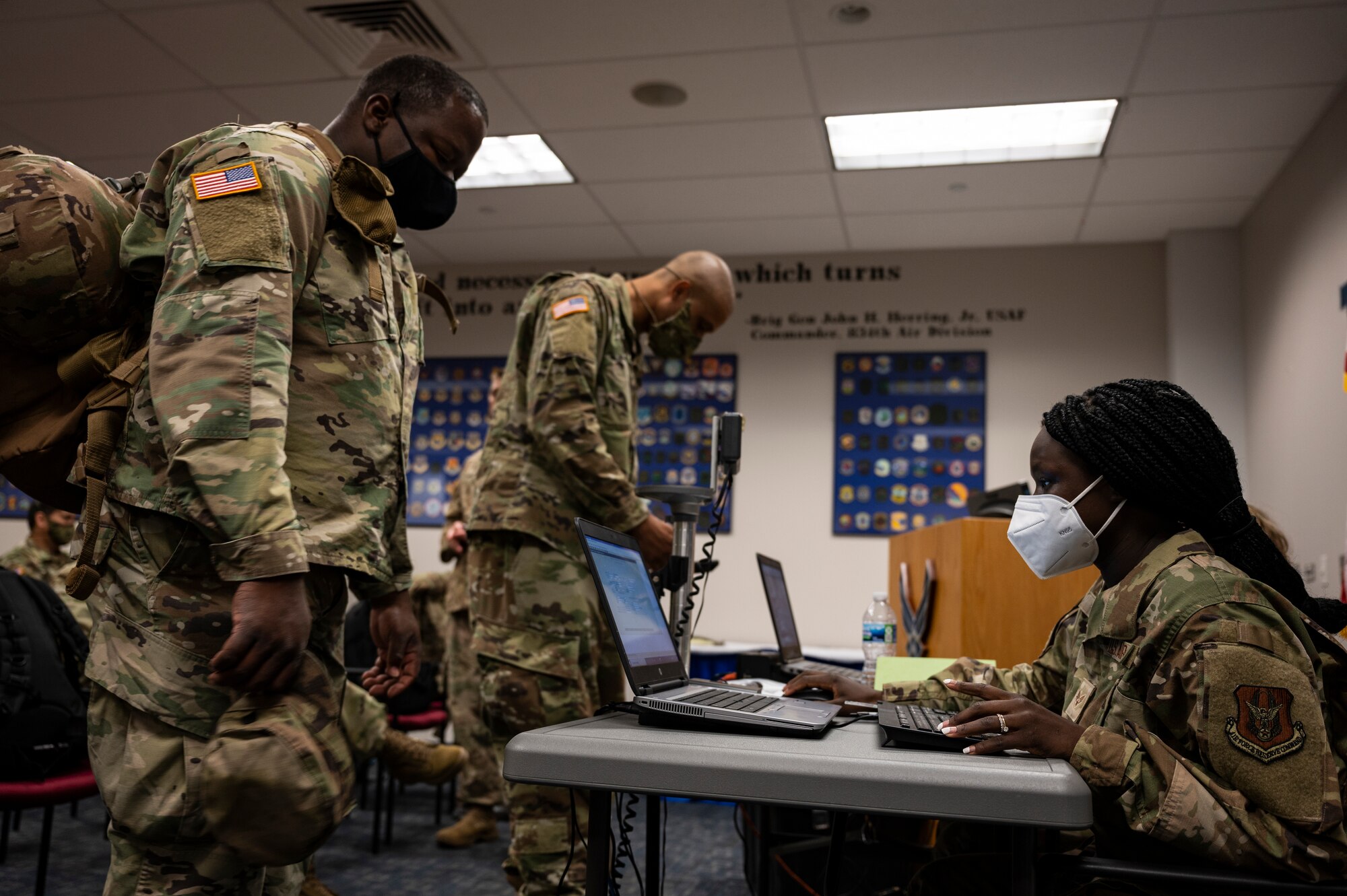 Senior Airman Gnecco Chuol, 32nd Aerial Port Squadron passenger service operations technician, adds a U.S. Army Soldier to a flight manifest at the Pittsburgh International Airport Air Reserve Station, Pennsylvania, May 28, 2021.