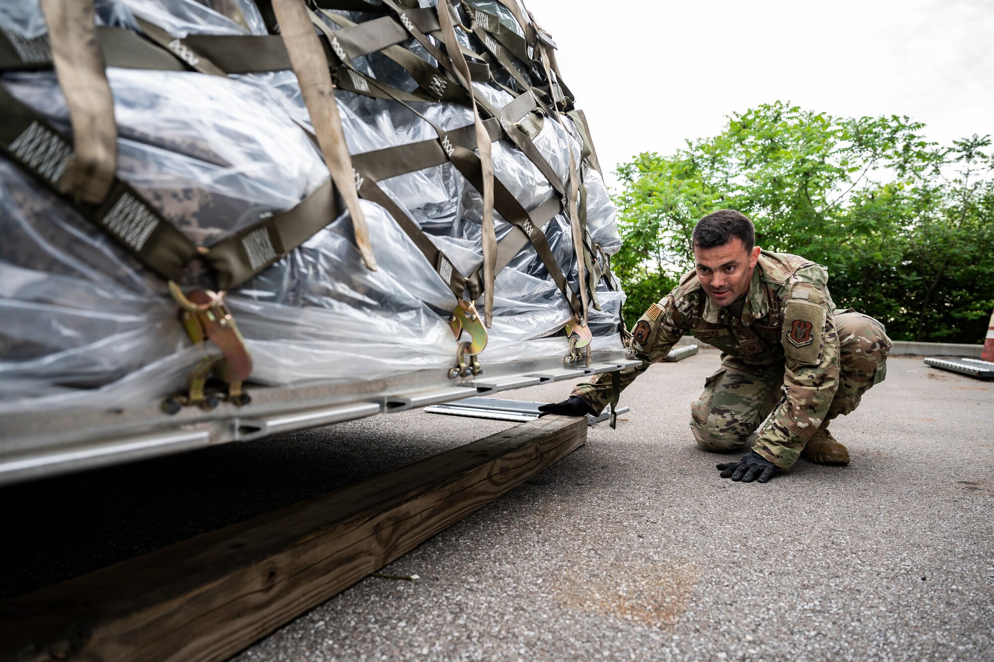 Master Sgt. Jeff Dunlap, 32nd Aerial Port Squadron readiness and resources noncommissioned officer, manuevers a board in order to weigh a pallet of cargo at the Pittsburgh International Airport Air Reserve Station, Pennsylvania, May 28, 2021.