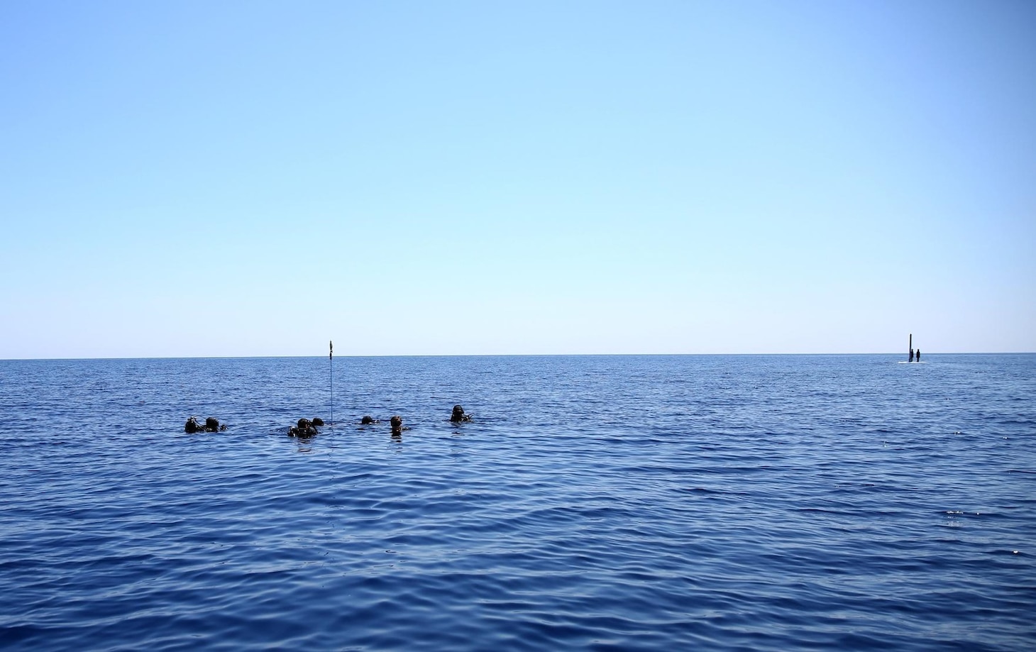 (June 28, 2021) U.S. Navy SEALs await recovery by Virginia-class attack submarine USS New Mexico (SSN779) during interoperability training in the Mediterranean Sea, June 28, 2021. This training demonstrated the ability for submarines to seamlessly integrate SEALs into Navy missions in the U.S. Sixth Fleet area of operations to ensure global access, security, and stability in the maritime domain. U.S. Sixth Fleet, headquartered in Naples, Italy, conducts the full spectrum of joint and naval operations, often in concert with allied, and interagency partners, in order to advance U.S. national interests and security and stability in Europe and Africa.