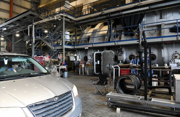 Lt. Col. Justin Tolliver, director of operations, Space Test Branch, Test Division, Arnold Engineering Development Complex, talks about the J-6 Large Rocket Motor Test Facility to an attendee of the AEDC “Hap Arnold Day” 70th Anniversary Celebration Open House, June 26, 2021, at Arnold Air Force Base, Tenn. In the background is the test cell of J-6, used to test solid rocket motors, such as those in the Minuteman III ICBMs. (U.S. Air Force photo by Jill Pickett)