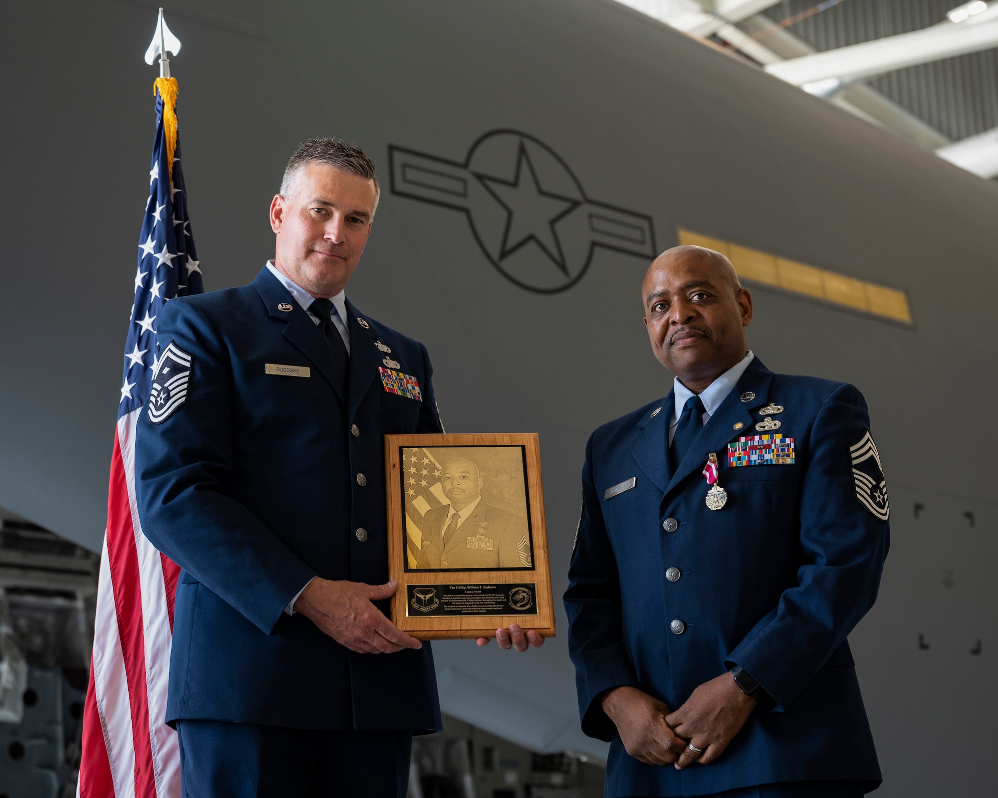 Master Sgt. James Rucosky, 911th Logistics Readiness Squadron first sergeant, presents a plaque to Chief Master Sgt. William T. Andrews, 911th LRS superintendent, during Andrews retirement ceremony at the Pittsburgh International Airport Air Reserve Station, Pennsylvania, June 5, 2021.