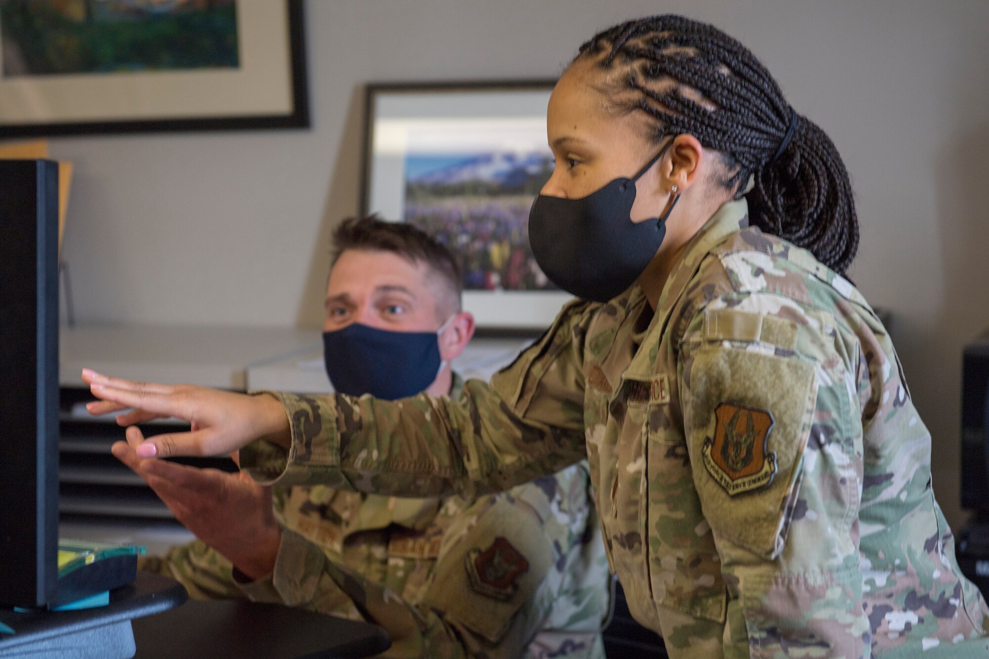 Capt. Danielle L. Daley, operations officer with the 911th Force Support Squadron, and Staff Sgt. Travis A. Hayton, customer support supervisor with the 911th FSS, review a personnel data system at Pittsburgh International Airport Air Reserve Station, Pennsylvania, May 11, 2021.