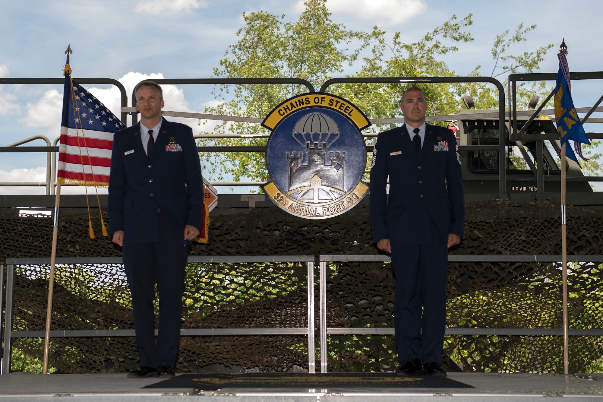 Maj. Erik Hofmeyer, commander of the 32nd Aerial Port Squadron, and Chief Master Sgt. Michael C. Heim, 32nd APS squadron superintendent, stand at attention for the promotion ceremony at the Pittsburgh International Airport Air Reserve Station, Pennsylvania, June 5, 2021.