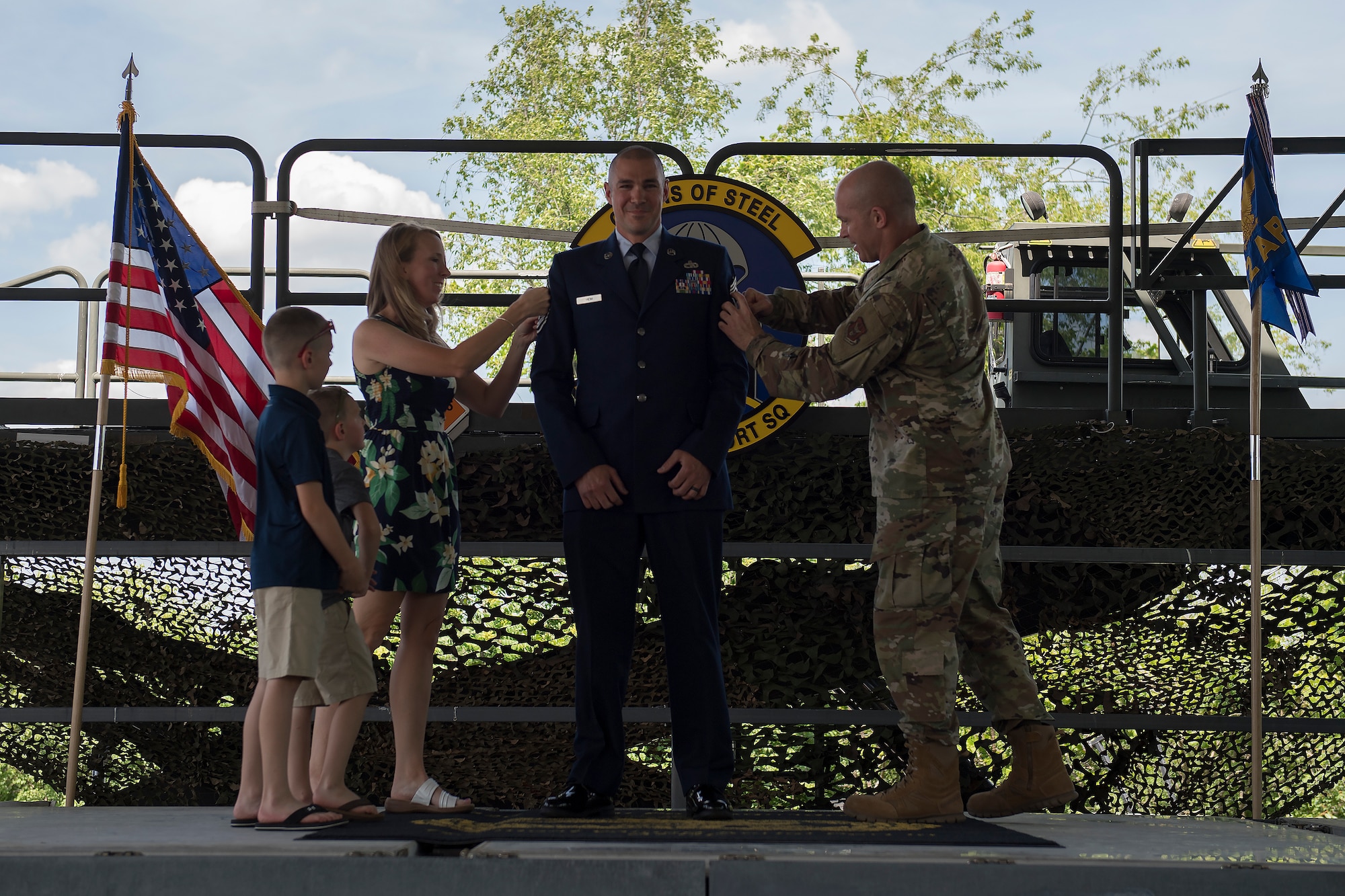 Chief Master Sgt. Michael C. Heim, squadron superintendent of the 32nd Aerial Port Squadron, receives his new rank from his family and Chief Master Sgt. Dennis G. Jendrzejewski, 911th Maintenance Group superintendent, at the Pittsburgh International Airport Air Reserve Station, Pennsylvania, June 5, 2021.