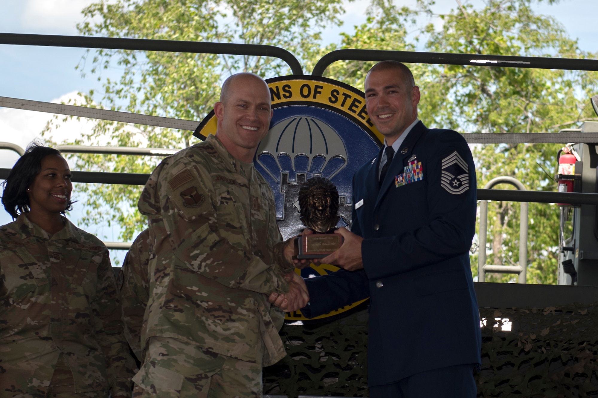 Chief Master Sgt. Michael C. Heim, squadron superintendent of the 32nd Aerial Port Squadron, receives the Chief’s Bust from Chief Master Sgt. Dennis G. Jendrzejewski, 911th Maintenance Group superintendent, at the Pittsburgh International Airport Air Reserve Station, Pennsylvania, June 5, 2021.