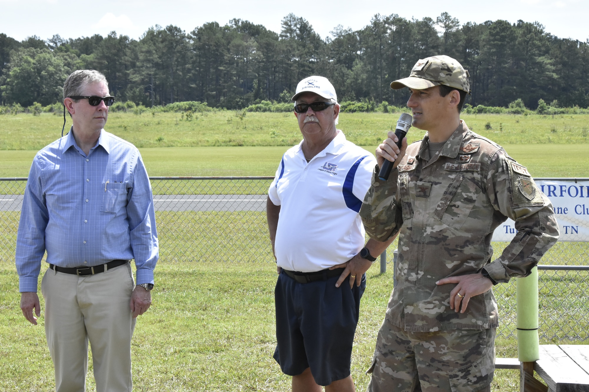 Arnold Engineering Development Complex Commander Col. Jeffrey Geraghty, right, addresses attendees during a June 26, 2021, event hosted by the Coffee Airfoilers Model RC Club to coincide with the Arnold Engineering Development Complex 70th anniversary celebration. Also pictured is Coffee Airfoilers Club President Don Cleveland, center, and AEDC Vice Director Jason Coker. Youth participating in the event were tasked with assembling small balsa wood airplanes, with top prizes going to those whose planes flew the farthest from the launch line. (U.S. Air Force photo by Bradley Hicks)