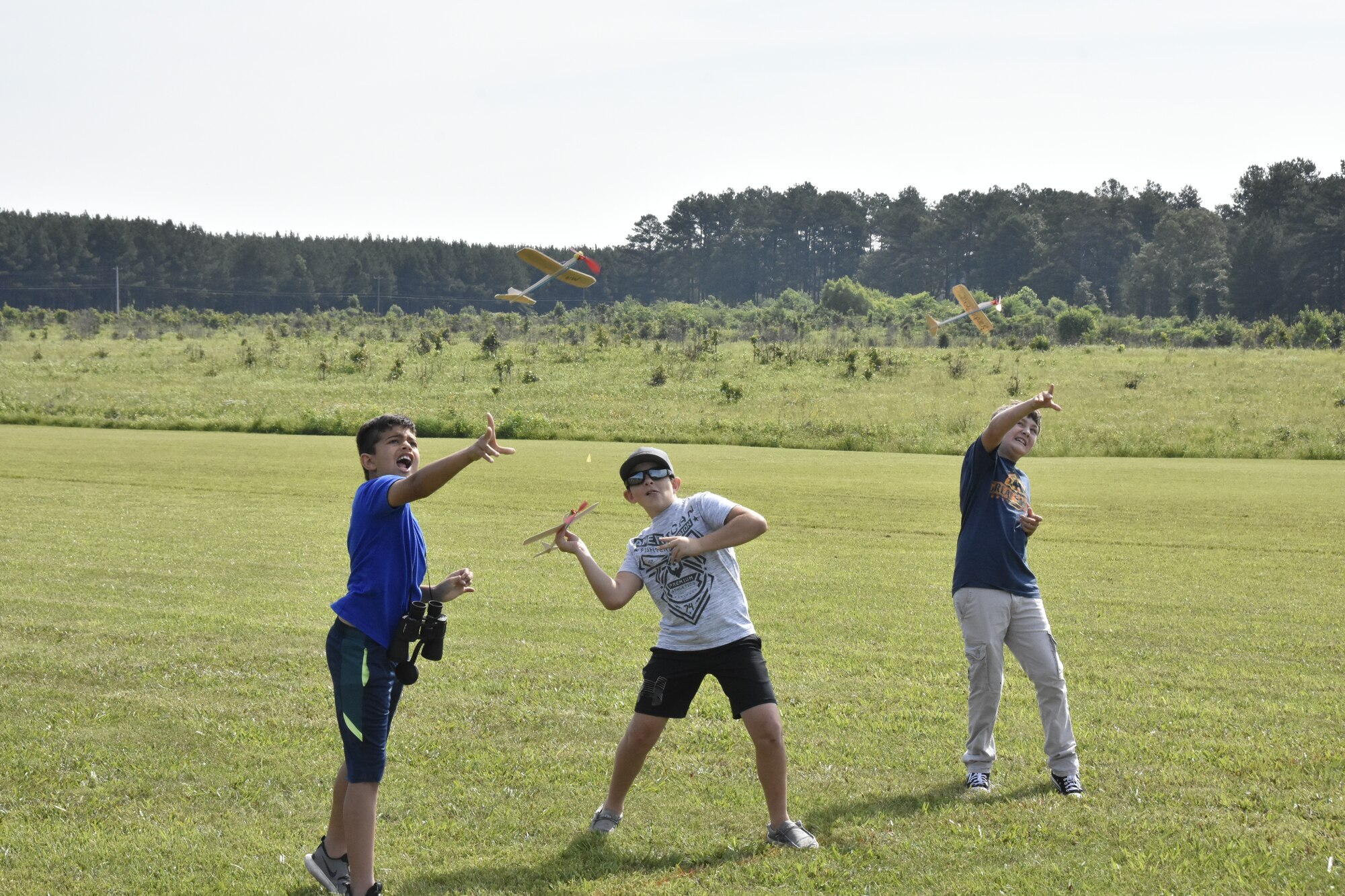 Miland Bonner, left, Bryce Spencer, center and Brandon Prince give their balsa wood planes a toss during a June 26, 2021, event hosted by the Coffee Airfoilers Model RC Club to coincide with the Arnold Engineering Development Complex 70th anniversary celebration. (U.S. Air Force photo by Bradley Hicks)