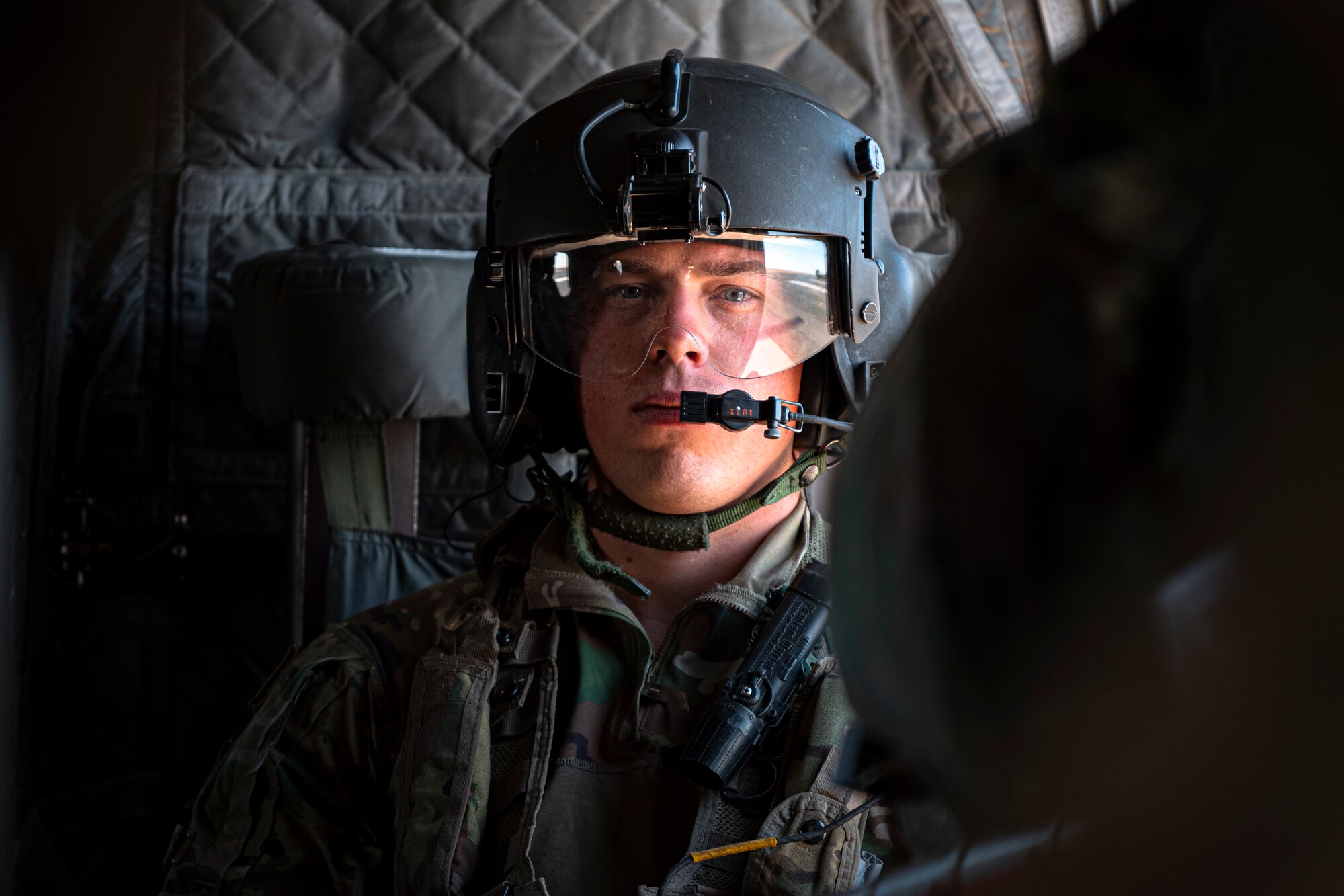 A photo of a Soldier in a seat of a CH-47 Chinook