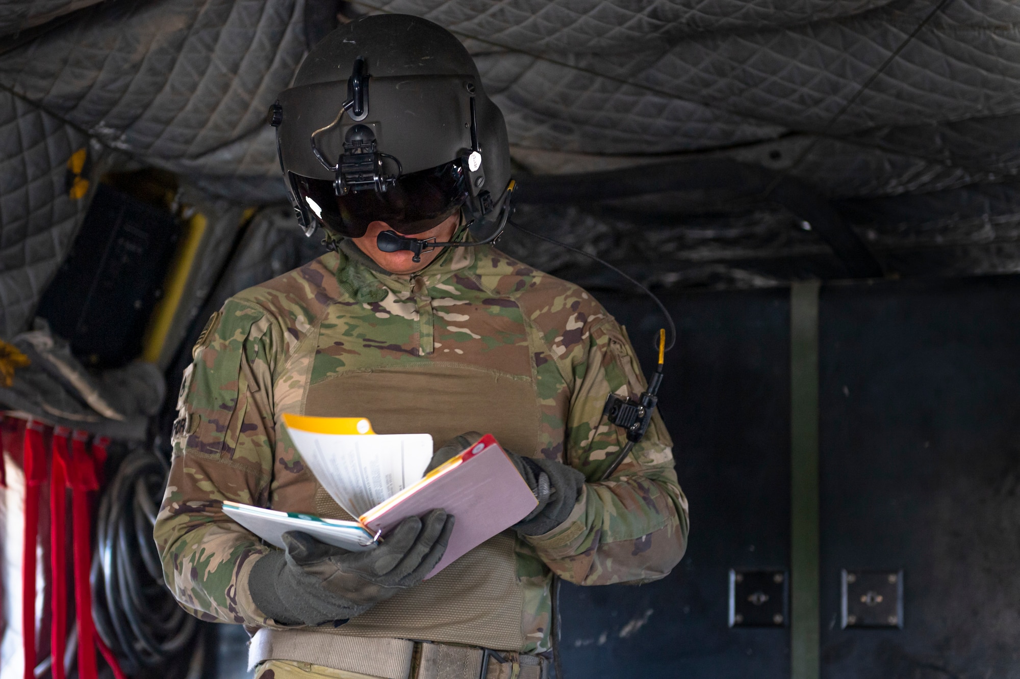 A photo of a Soldier looking through a manual