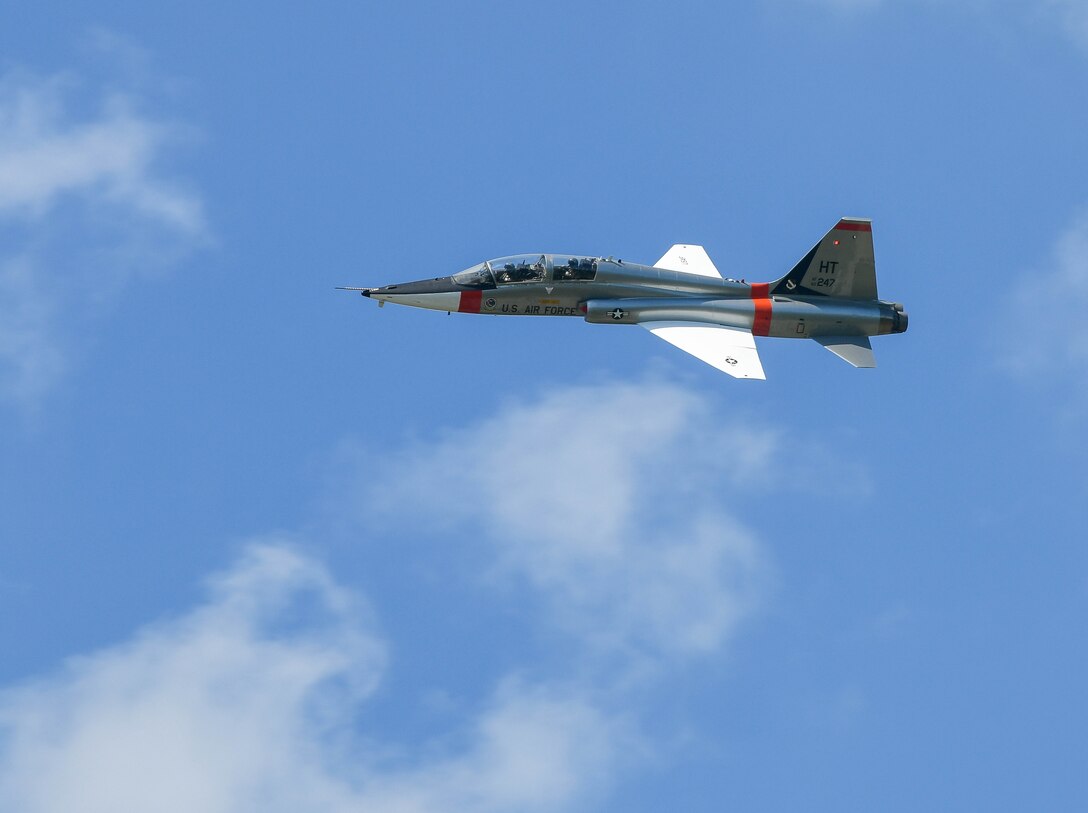 A T-38 Talon is flown over Arnold Air Force Base by Airmen of the 586th Flight Test Squadron, 704th Test Group, Arnold Engineering Development Complex, during a flag retreat ceremony after the AEDC “Hap Arnold Day” 70th Anniversary June 26, 2021. The aircraft was flown by Lt. Col. Alex “Cuda” Wolfard and Maj. Ali “Axle” Hamidani. (U.S. Air Force photo by Jill Pickett)