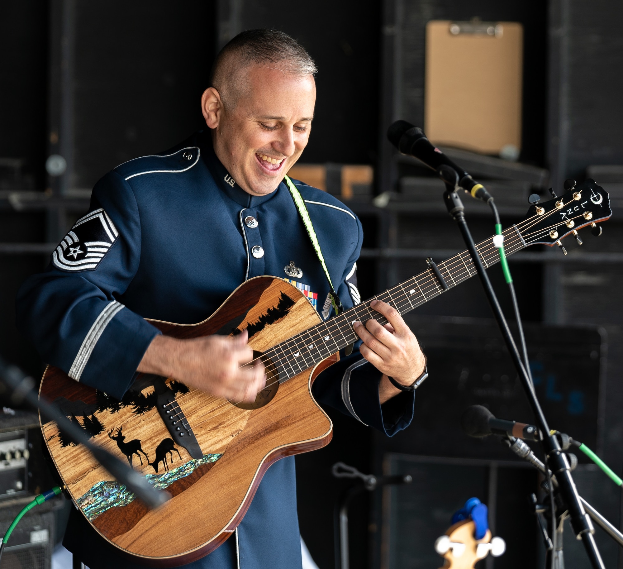 U.S. Air Force Senior Master Sgt. Joseph Haughton, U.S. Air Force Band ensemble Celtic Aire fretted instrumentalist and vocalist, plays the acoustic guitar at the Alaska Scottish Highland Games in Palmer, Alaska, June 26, 2021.