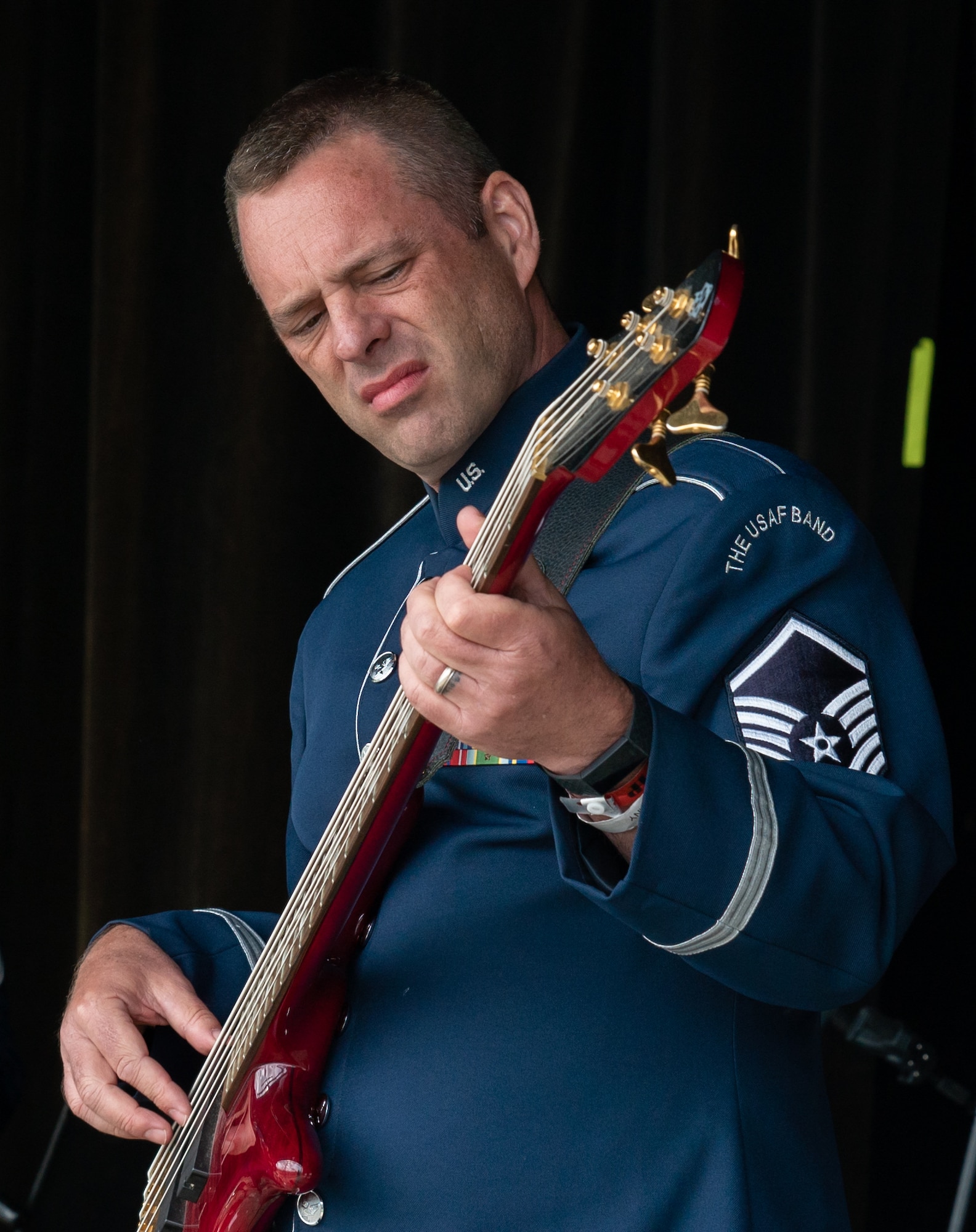 U.S. Air Force Master Sgt. Eric Sullivan, U.S. Air Force Band ensemble Celtic Aire bassist and vocalist, plays bass guitar at the Alaska Scottish Highland Games in Palmer, Alaska, June 26, 2021.