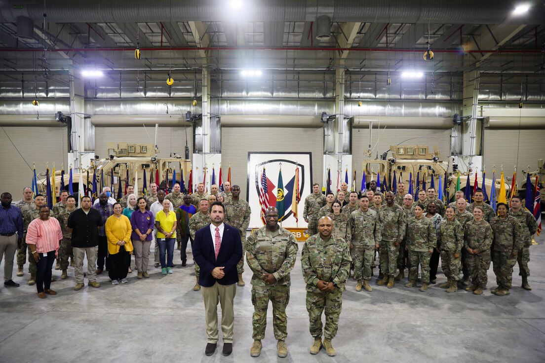 Soldiers and civilians from the 408th Contracting Support Brigade assemble following  a change of command ceremony at Camp Arifjan, Kuwait, June 30, 2021. During the ceremony, Col. Anthony Hughley assumed command of the 408th CSB from outgoing commander Col. Richard Pfeiffer Jr.. (U.S. Army photo by Sgt. Jimmie Baker 1TSC Public Affairs)