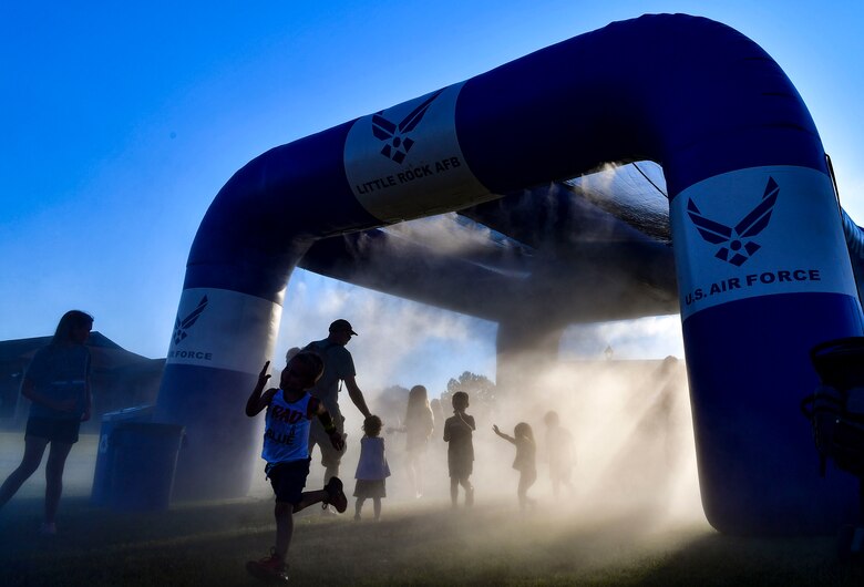Airmen and their families run through one of the attractions