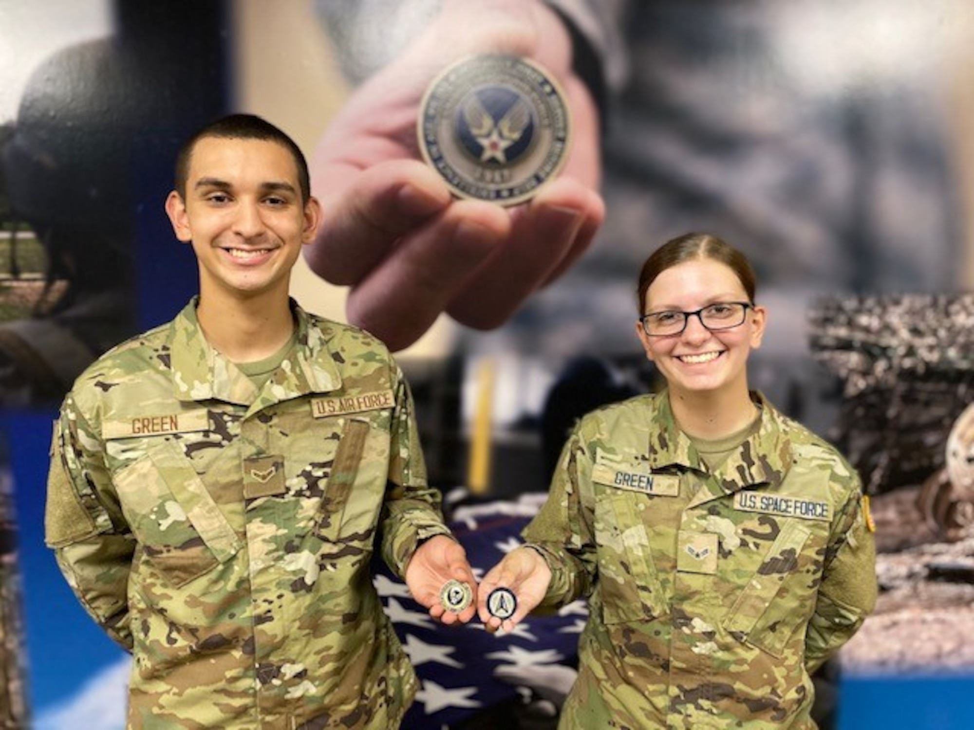 Air Force Airman and Space Force Guardian show their coins after graduation.