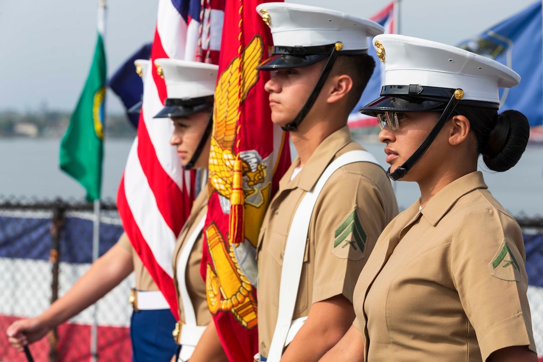 Four Marines stand in formation.