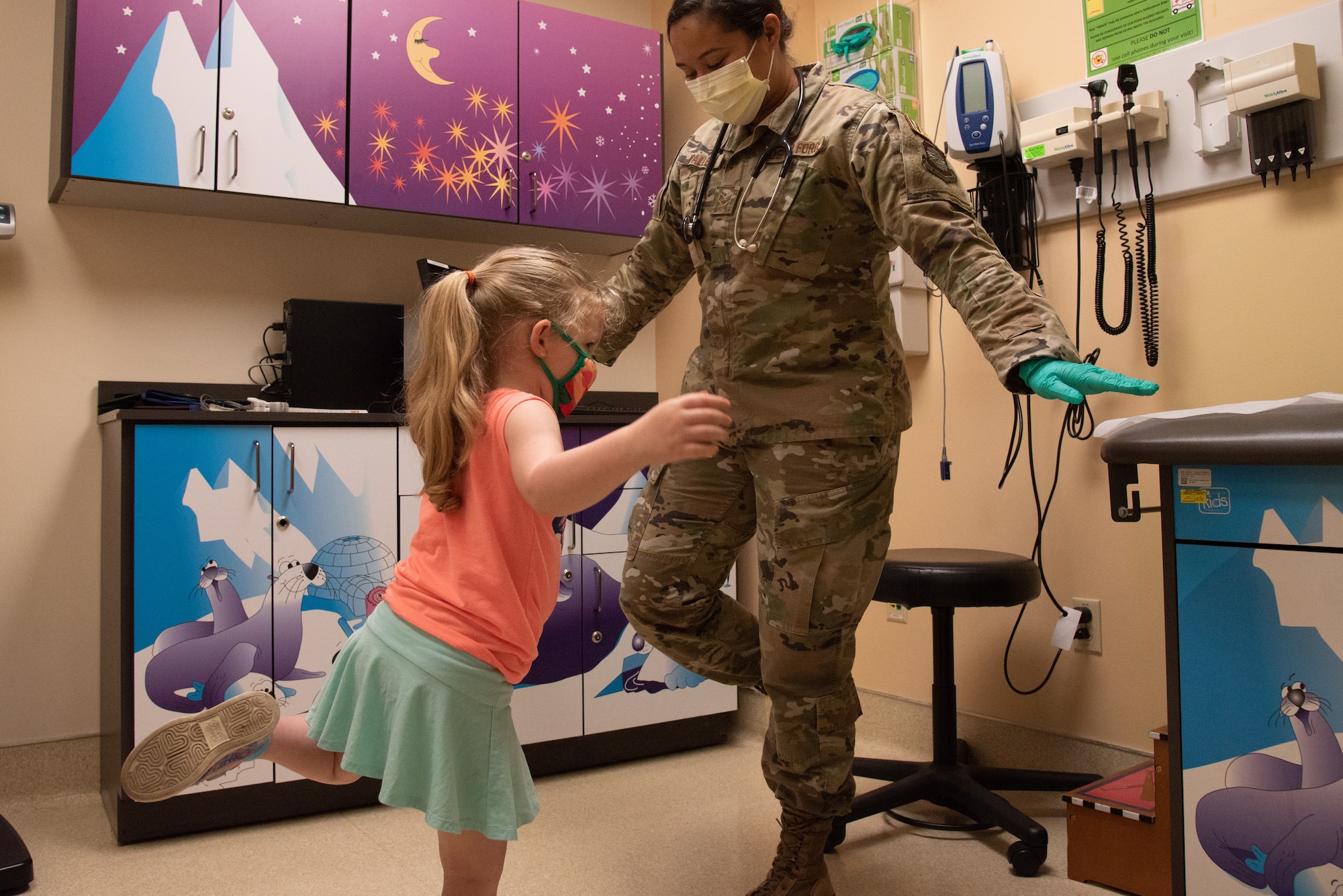 U.S. Air Force Senior Airman Julia Vallejo, 375th Health Care Operations Squadron Pediatrics Clinic aerospace medical technician, leads the patient through a balance test on Scott Air Force Base, Illinois, June 28, 2021. Vallejo used the test to gauge motor performance in the patient. (U.S. Air Force photo by Airman 1st Class Stephanie Henry)