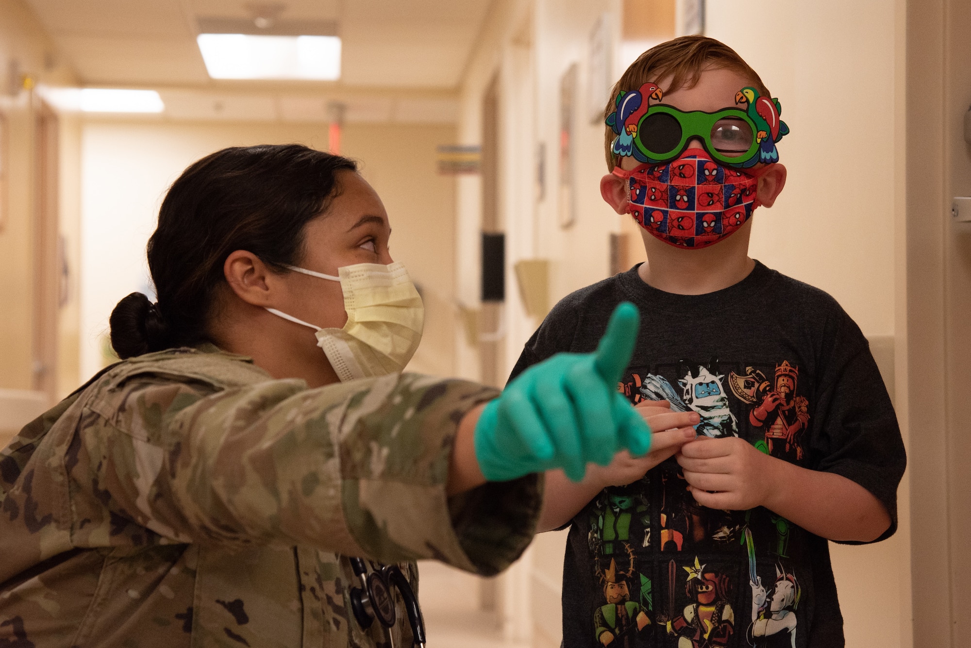 U.S. Air Force Senior Airman Julia Vallejo, 375th Health Care Operations Squadron Pediatrics Clinic aerospace medical technician directs a patient through a vision test on Scott Air Force Base, Illinois, June 28, 2021. Vallejo checked for any changes in the patient's current prescription. (U.S. Air Force photo by Airman 1st Class Stephanie Henry)
