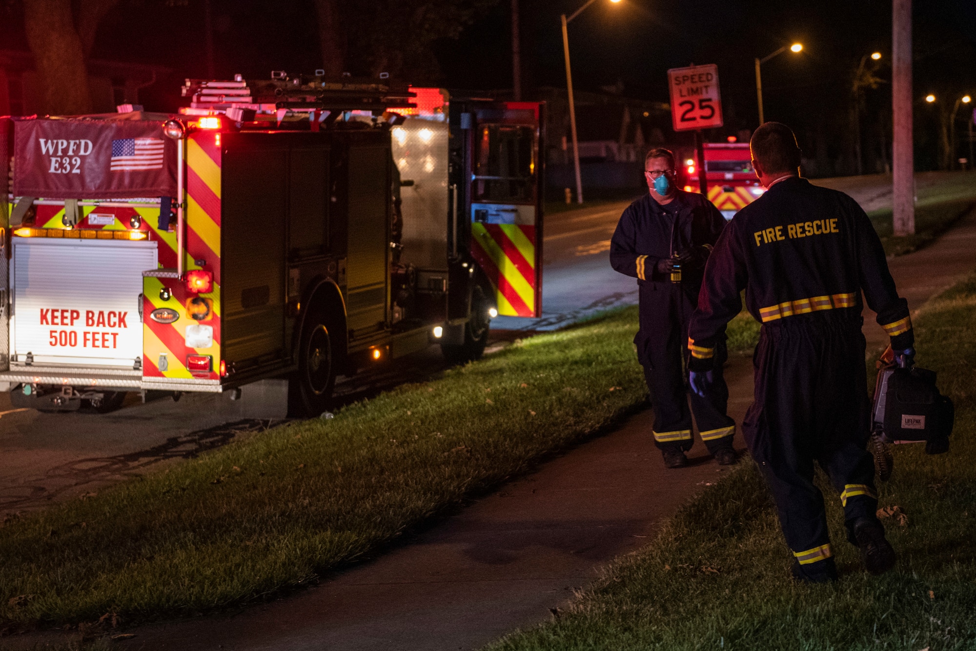 Firefighters return to their truck after responding to a call for medical help in base housing, June 23, 2021 at Wright-Patterson Air Force Base, Ohio.  The base has three stations strategically located to ensure a response time of 5 minutes or less when the call comes in. (U.S. Air Force photo by Wesley Farnsworth)