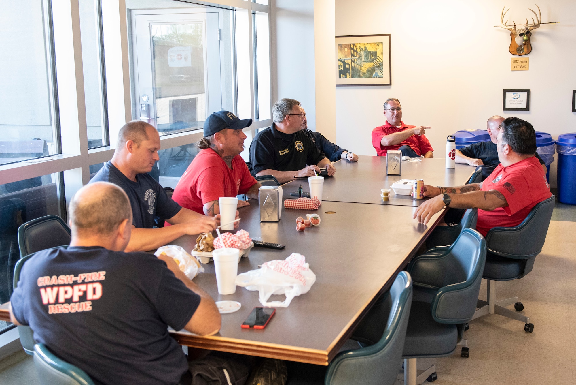 Firefighters with the 788th Civil Engineer Squadron Fire Department sit down for dinner inside Station 1, June 23, 2021, at Wright-Patterson Air Force Base, Ohio. The fire department is on call 24/7 all year and capable of responding anywhere on base within 5 minutes when a call for help comes in. (U.S. Air Force photo by Wesley Farnsworth)