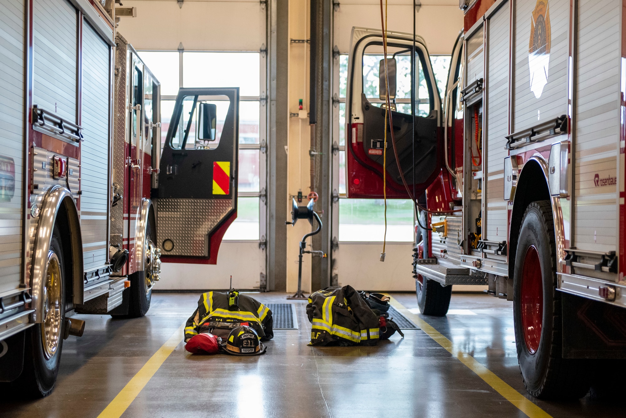 Bunker gear sits staged next to two fire trucks belonging to the 788th Civil Engineer Fire Department inside the bays at Station 1, June 23, 2021, at Wright-Patterson Air Force Base, Ohio. The fire department is on call 24/7 all year and capable of responding anywhere on base within 5 minutes when a call for help comes in. (U.S. Air Force photo by Wesley Farnsworth)