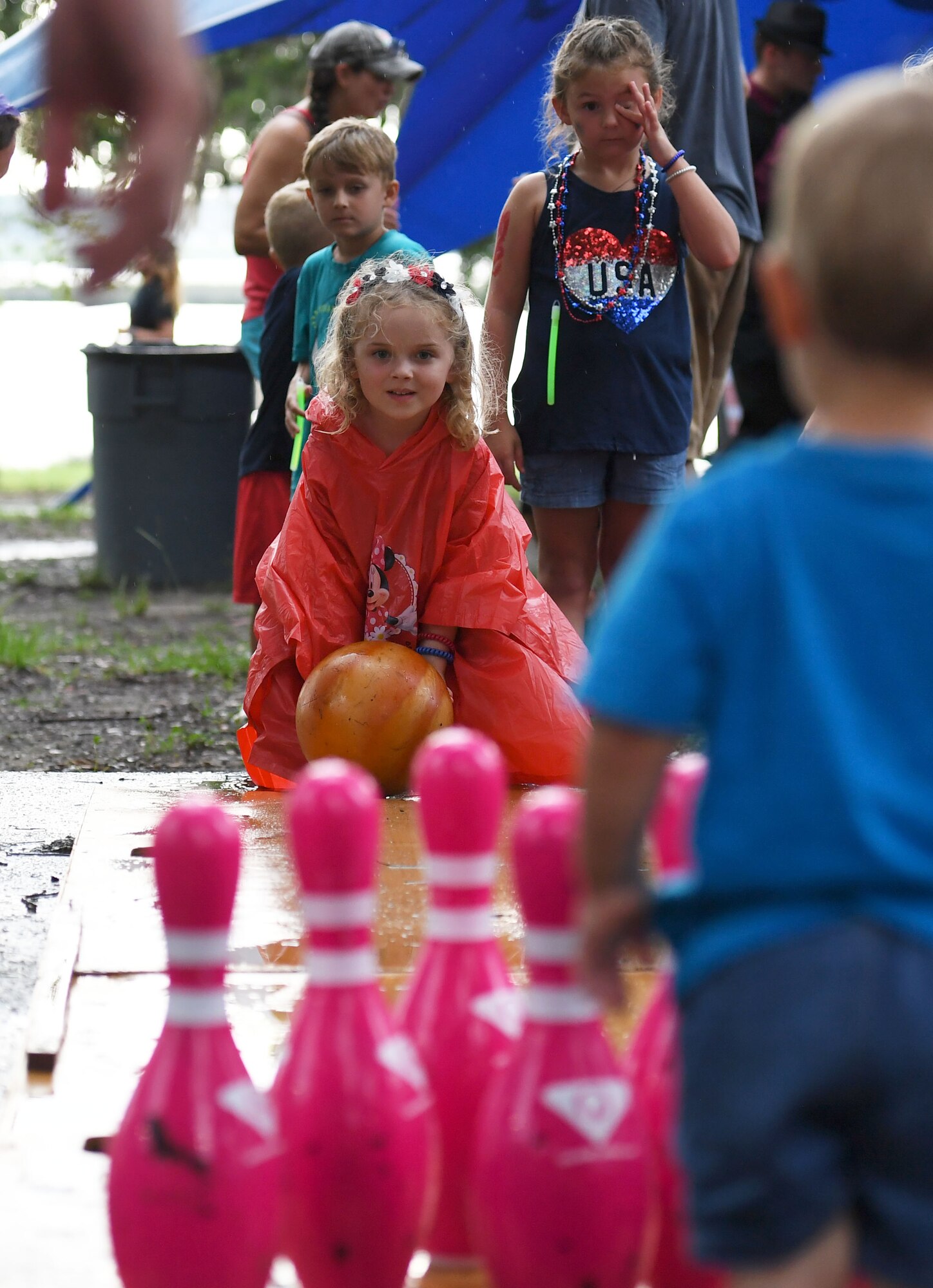 Zoya Lauderdale, niece of U.S. Air Force Airman 1st Class Cyrus Akbari, 334th Training Squadron student, takes a turn at bowling during Freedom Fest at Marina Park at Keesler Air Force Base, Mississippi, July 2, 2021. The event also included hot wings and watermelon eating competitions and fireworks. (U.S. Air Force photo by Kemberly Groue)