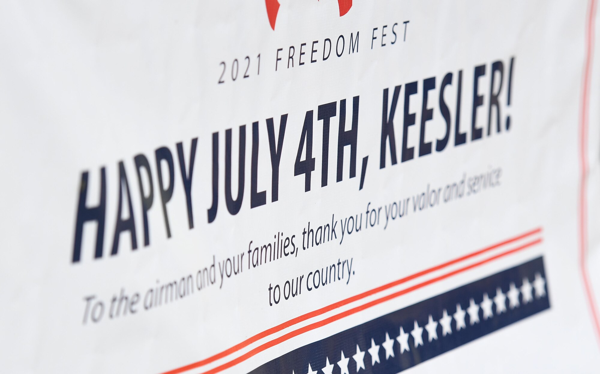 A banner is on display during Freedom Fest at Marina Park at Keesler Air Force Base, Mississippi, July 2, 2021. The event also included hot wings and watermelon eating competitions and fireworks. (U.S. Air Force photo by Kemberly Groue)