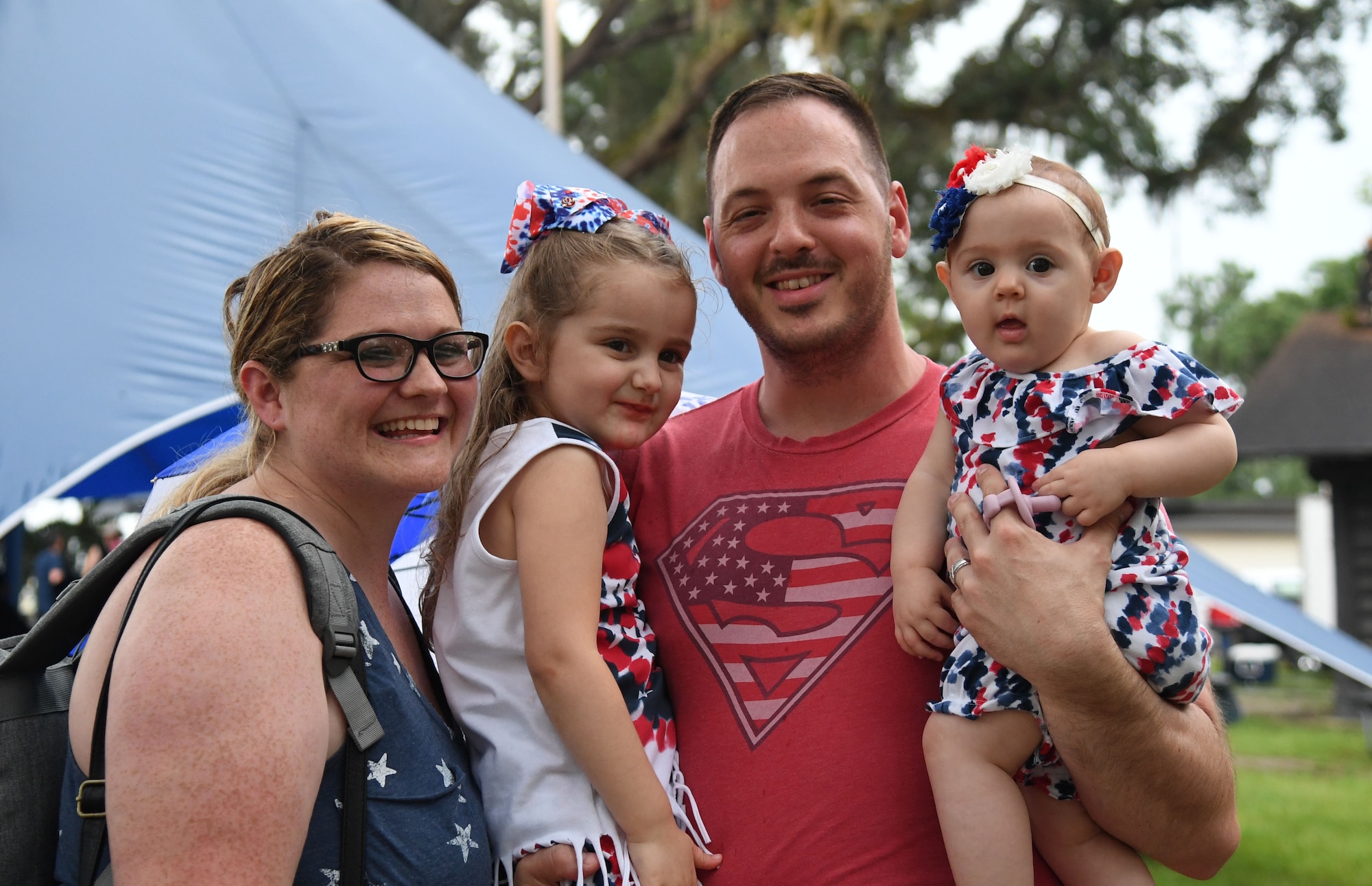 U.S. Air Force Staff Sgt. Adam Shramek, 335th Training Squadron instructor, and his family pose for a photo during Freedom Fest at Marina Park at Keesler Air Force Base, Mississippi, July 2, 2021. The event also included hot wings and watermelon eating competitions and fireworks. (U.S. Air Force photo by Kemberly Groue)