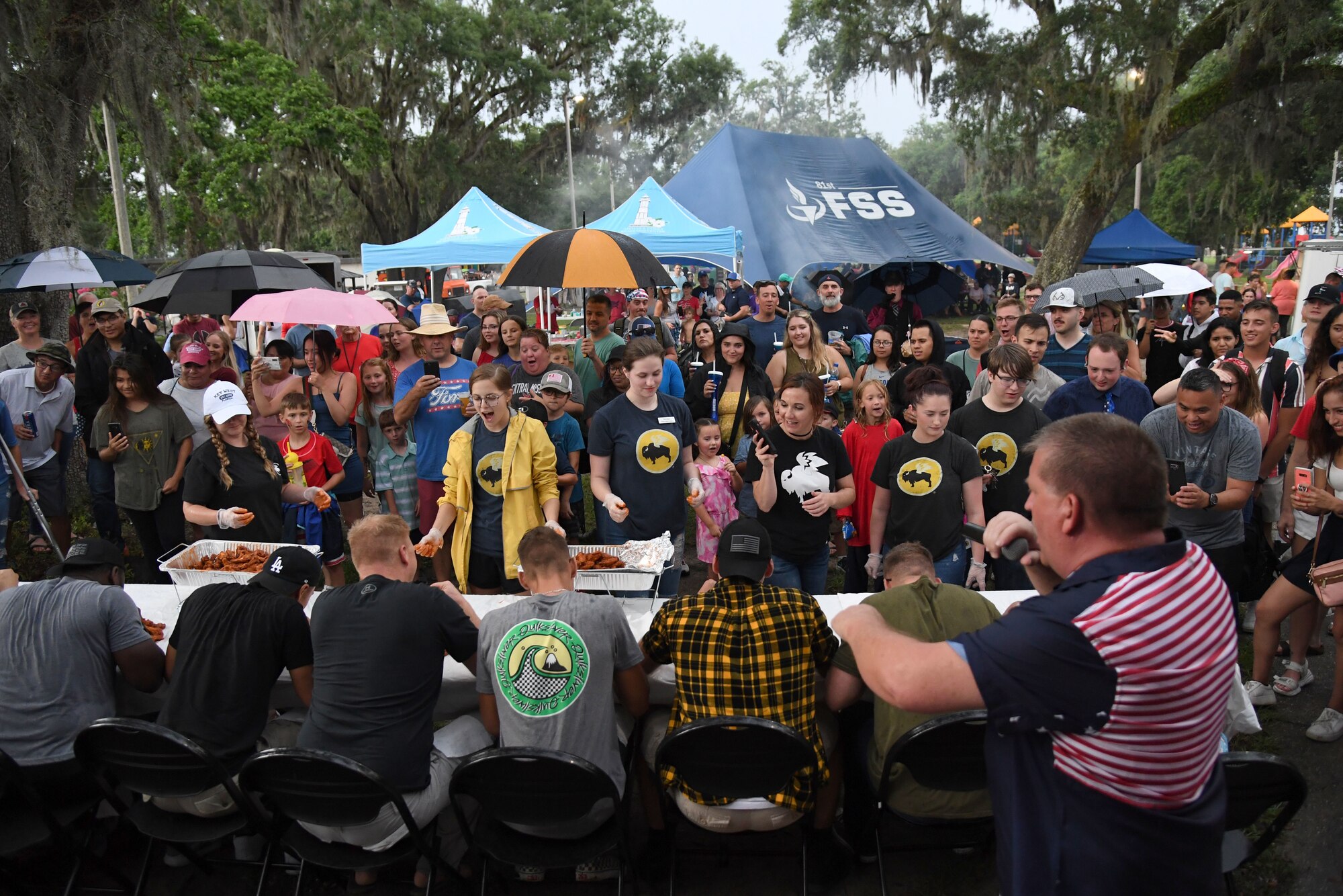 Keesler personnel and families gather to watch a wing eating contest during Freedom Fest at Marina Park at Keesler Air Force Base, Mississippi, July 2, 2021. The event also included hot dogs and watermelon eating competitions and fireworks. (U.S. Air Force photo by Kemberly Groue)