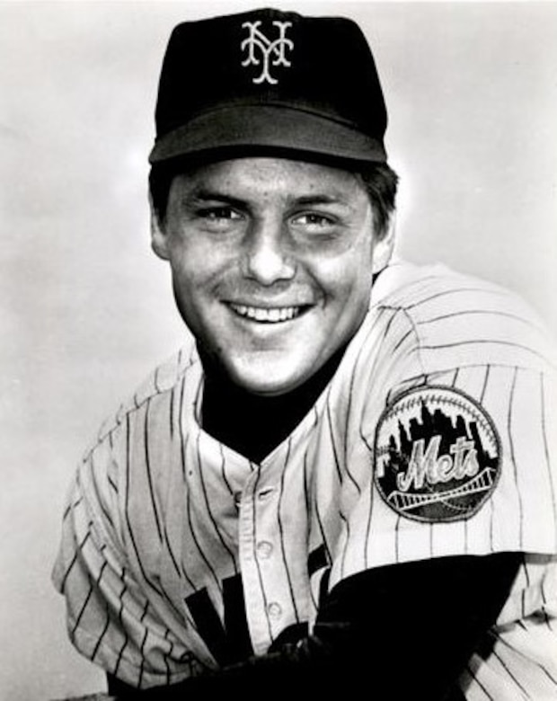 A baseball player smiles for the camera.