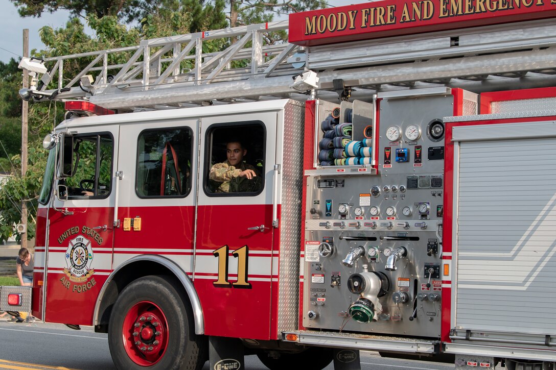 Photo of Airmen driving fire truck