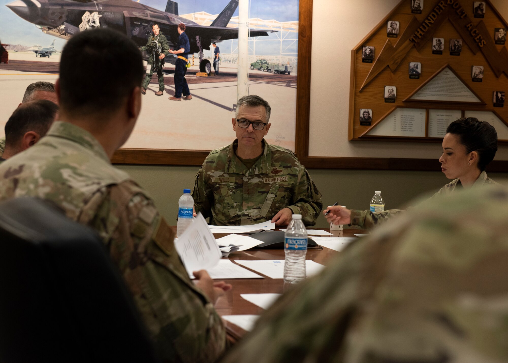 U.S. Air Force Maj. Gen. Craig Wills, center, 19th Air Force commander, and U.S. Air Force Chief Master Sgt. Kristina Rogers, 19th AF command chief, speak with Airmen assigned to the 56th Fighter Wing Fighter Country Spark team about potential innovative initiatives, June 29, 2021, at Luke Air Force Base, Arizona. Leadership from the 19th AF visited Luke AFB to engage with 56th Fighter Wing members while gaining a better understanding of the successes and challenges faced by the wing. The 56th FW’s mission is to train the world’s greatest fighter pilots and combat-ready Airmen. (U.S. Air Force photo by Tech. Sgt. Franklin R. Ramos)