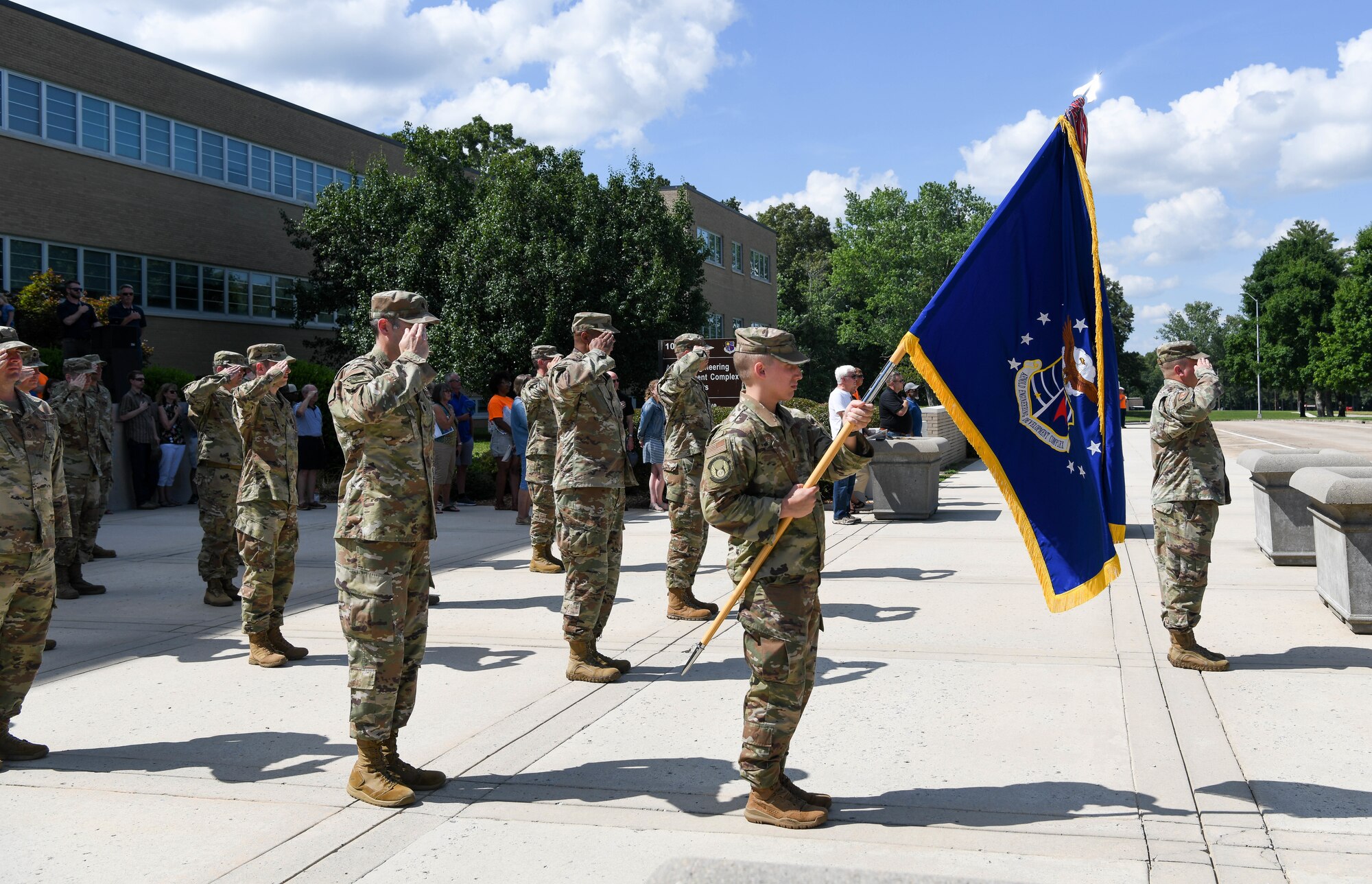 A detail of uniformed Airmen of Arnold Engineering Development Complex salute during a retreat ceremony after the AEDC “Hap Arnold Day” 70th Anniversary Celebration Open House, June 26, 2021, at Arnold Air Force Base, Tenn. (U.S. Air Force photo by Jill Pickett)