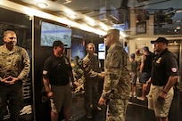 Brig. Gen. Ernest Litynski, center, Commanding General, 85th U.S. Army Reserve Support Command, receives a tour of the U.S. Army Special Operations display trailer from recruiters assigned to the U.S. Army Recruiting Battalion-Milwaukee during the Fourth of July NASCAR Cup Series race at Road America, Elkhart Lake, Wisconsin, July 4, 2021.