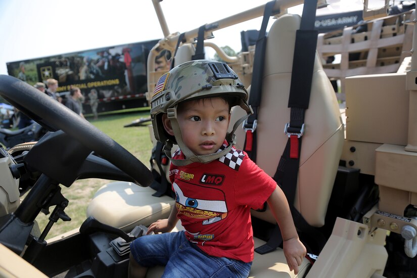 Michael Taylor, 3, pauses for a photo in an Army Polaris MRZR 4 during the Fourth of July NASCAR Cup Series race at Road America, Elkhart Lake, Wisconsin, July 4, 2021.