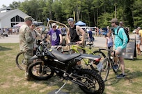 Cyclists are introduced to an Army Zero FX Z-Force 5.7 Electric Motorcycle during the Fourth of July NASCAR Cup Series race at Road America, Elkhart Lake, Wisconsin, July 4, 2021.