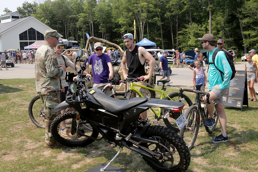 Cyclists are introduced to an Army Zero FX Z-Force 5.7 Electric Motorcycle during the Fourth of July NASCAR Cup Series race at Road America, Elkhart Lake, Wisconsin, July 4, 2021.